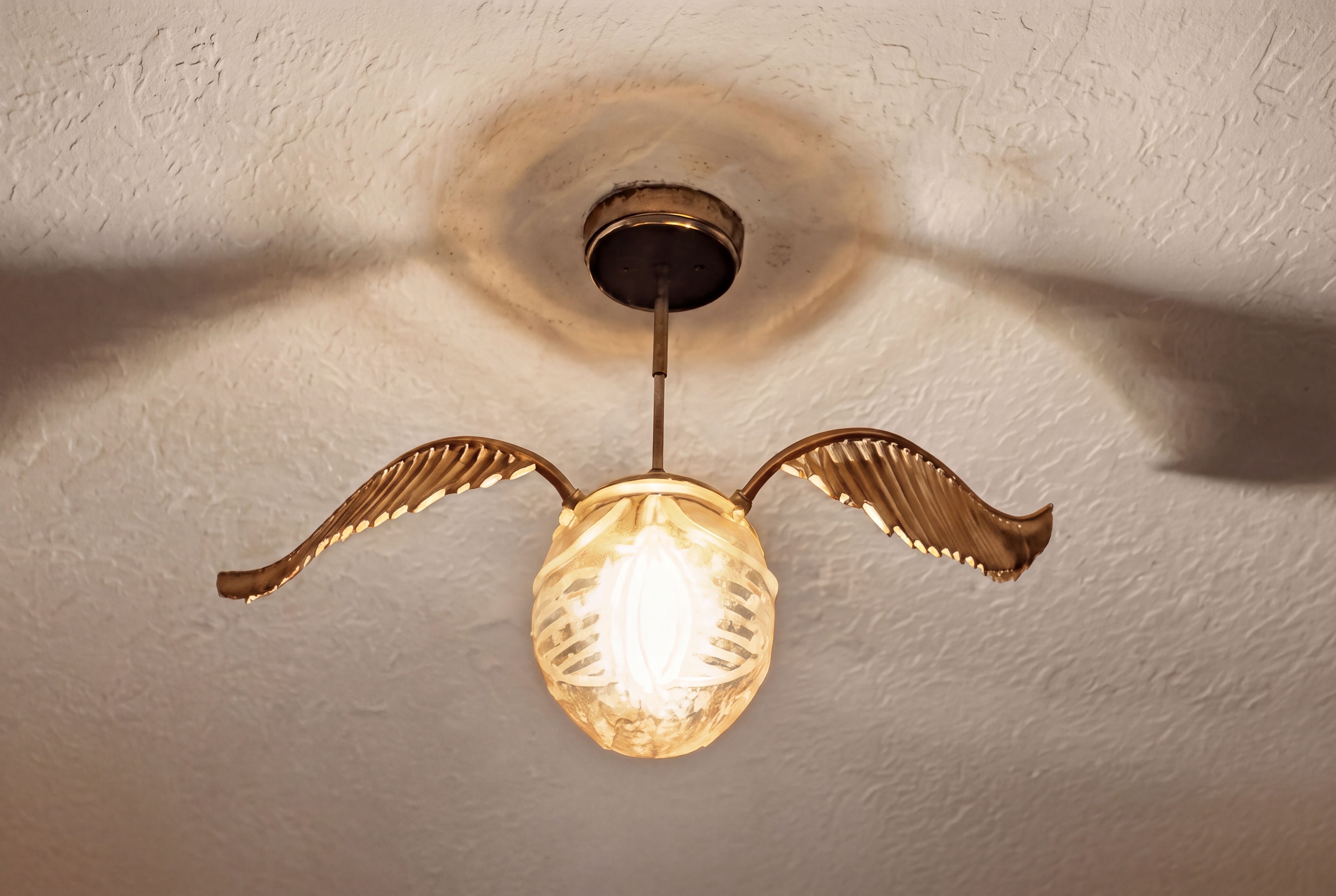 Whimsical winged ceiling light adds charm and cozy ambiance