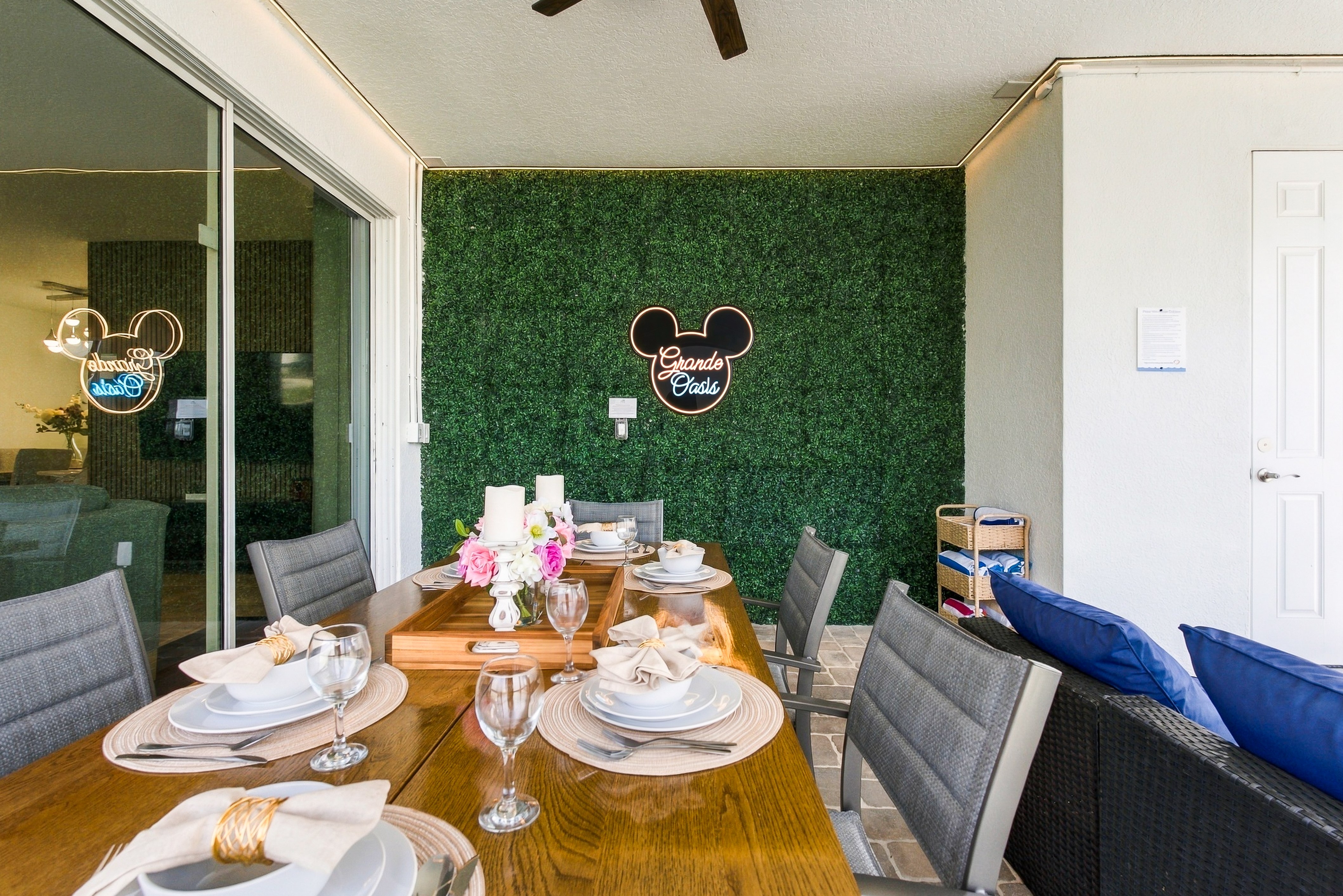 Covered patio with stylish dining setup and cozy lounge seating