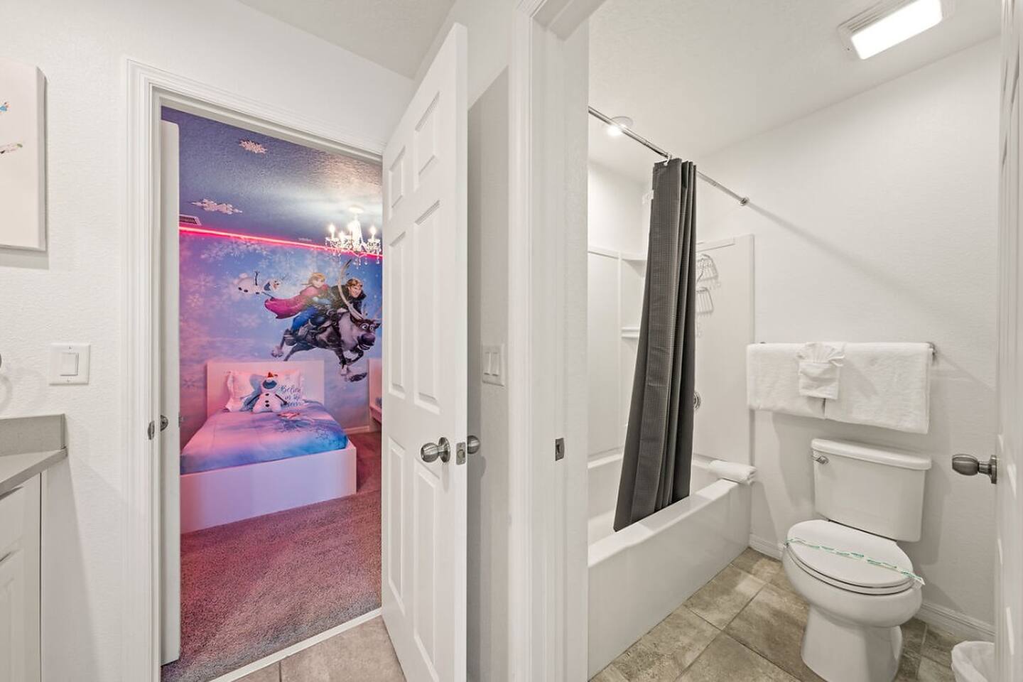 Bright, clean Jack & Jill bathroom shared between two upstairs bedrooms. Full tub for bubble baths, plush towels & kid-friendly setup. Parents love the convenience—kids love the proximity to their Frozen room!