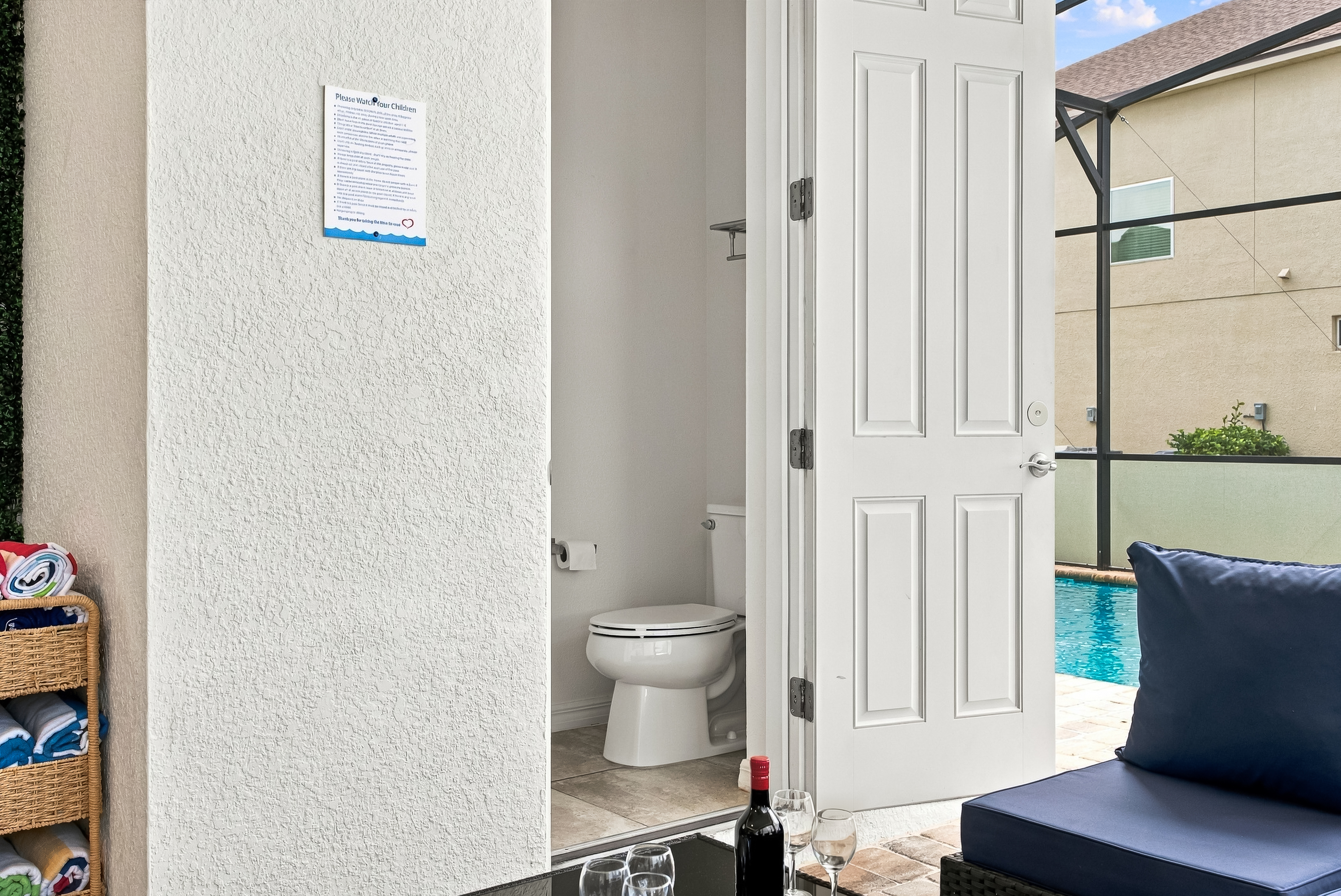 Poolside half-bath with patio seating and easy screened pool access