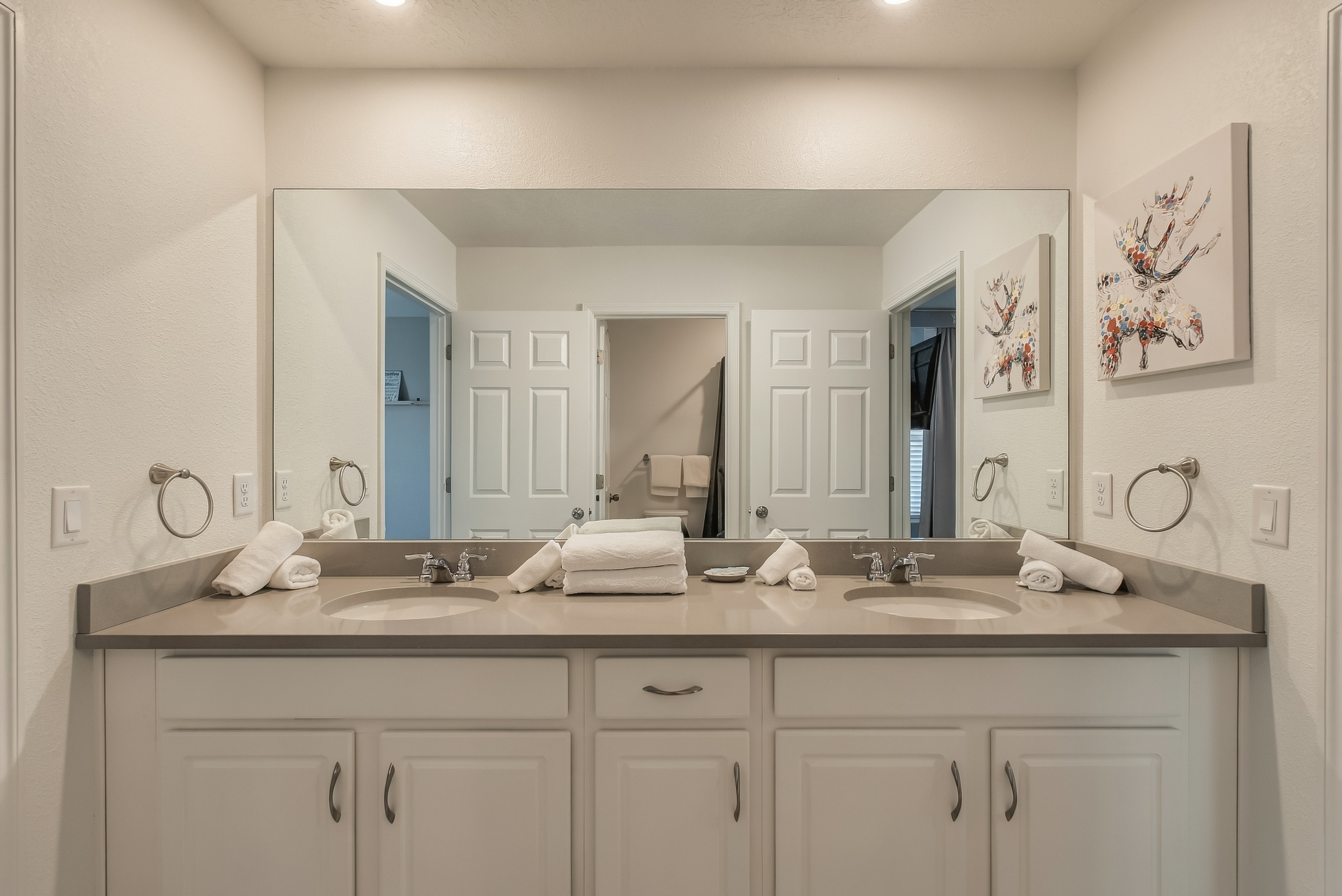 Bright double-vanity bathroom with spacious counter and elegant finishes