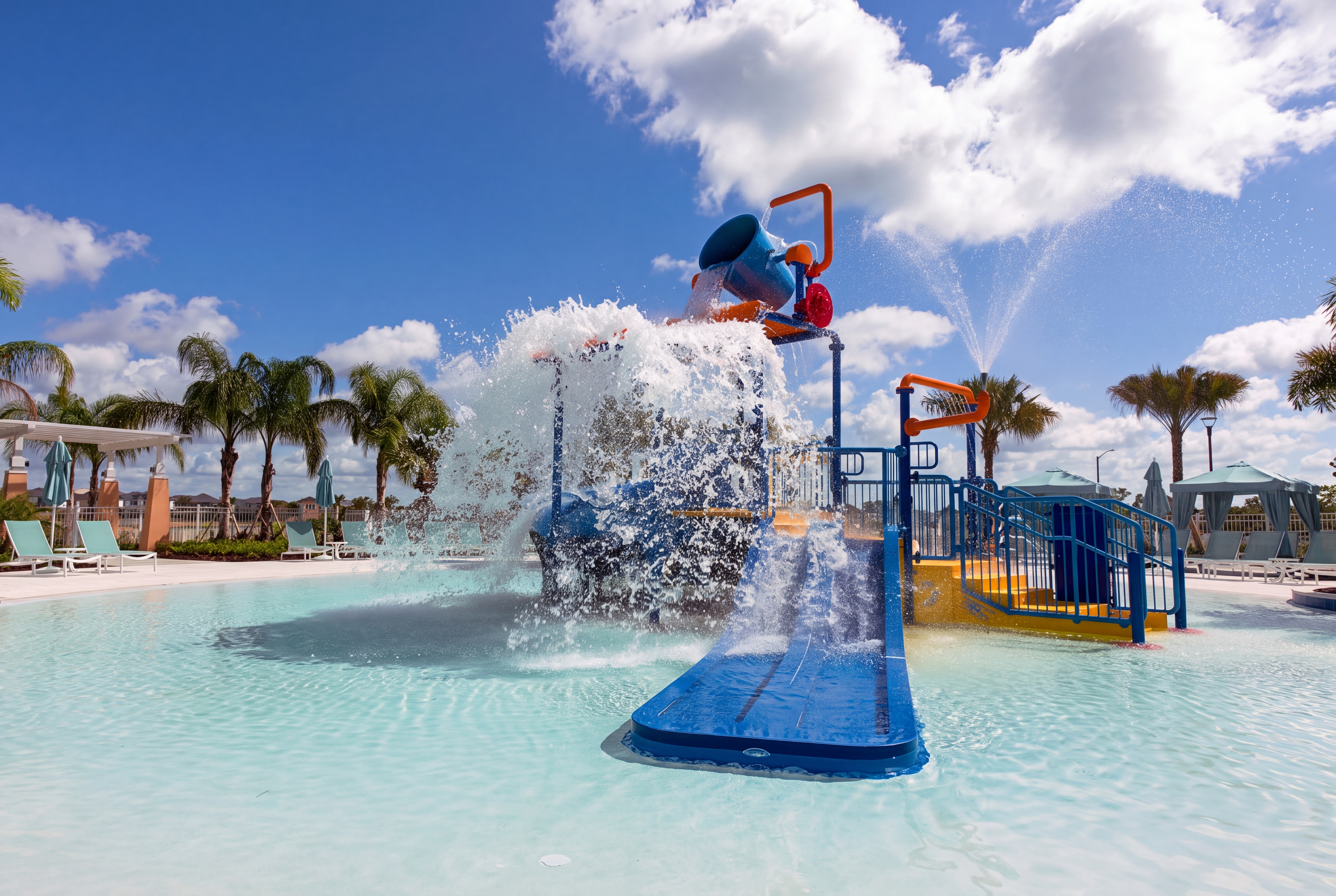 Family-friendly splash pad with slides, sprayers, and resort-style pool fun