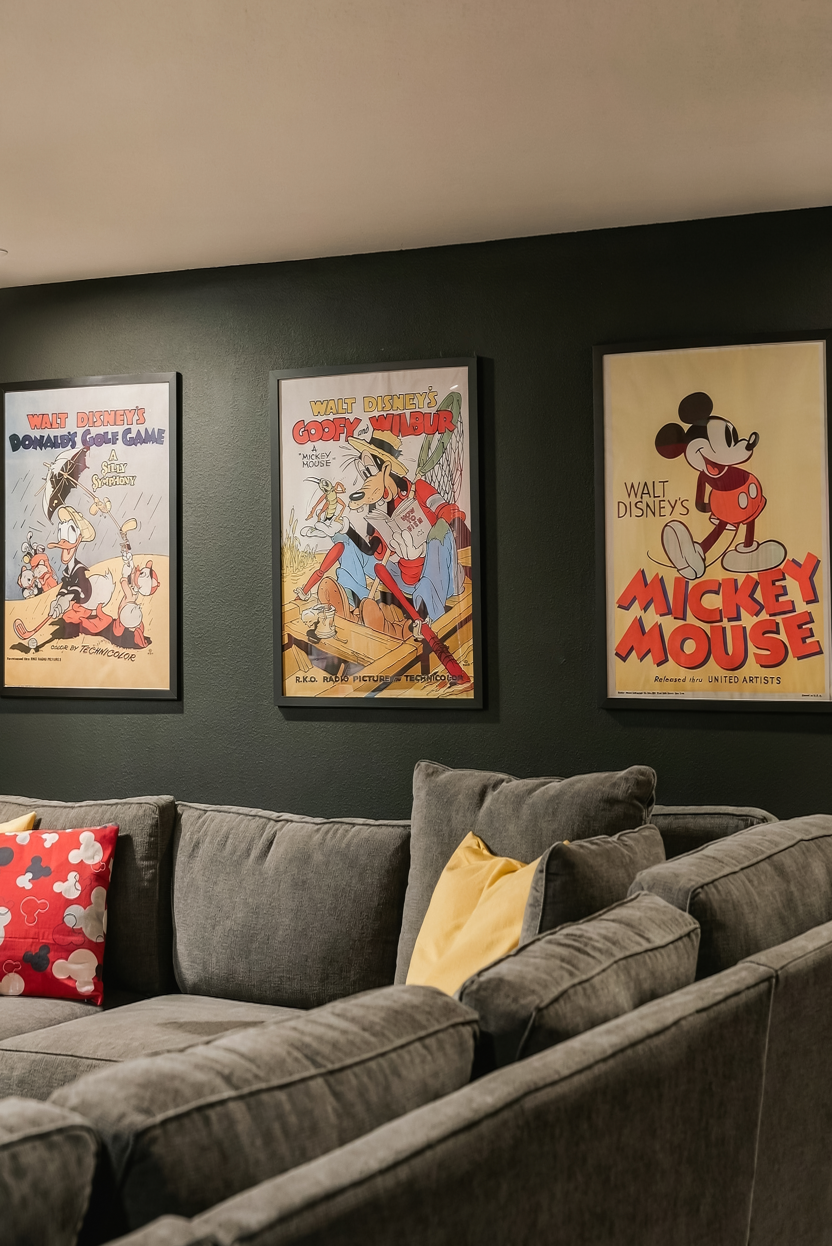 Cozy lounge with plush sectional and vintage Disney wall art