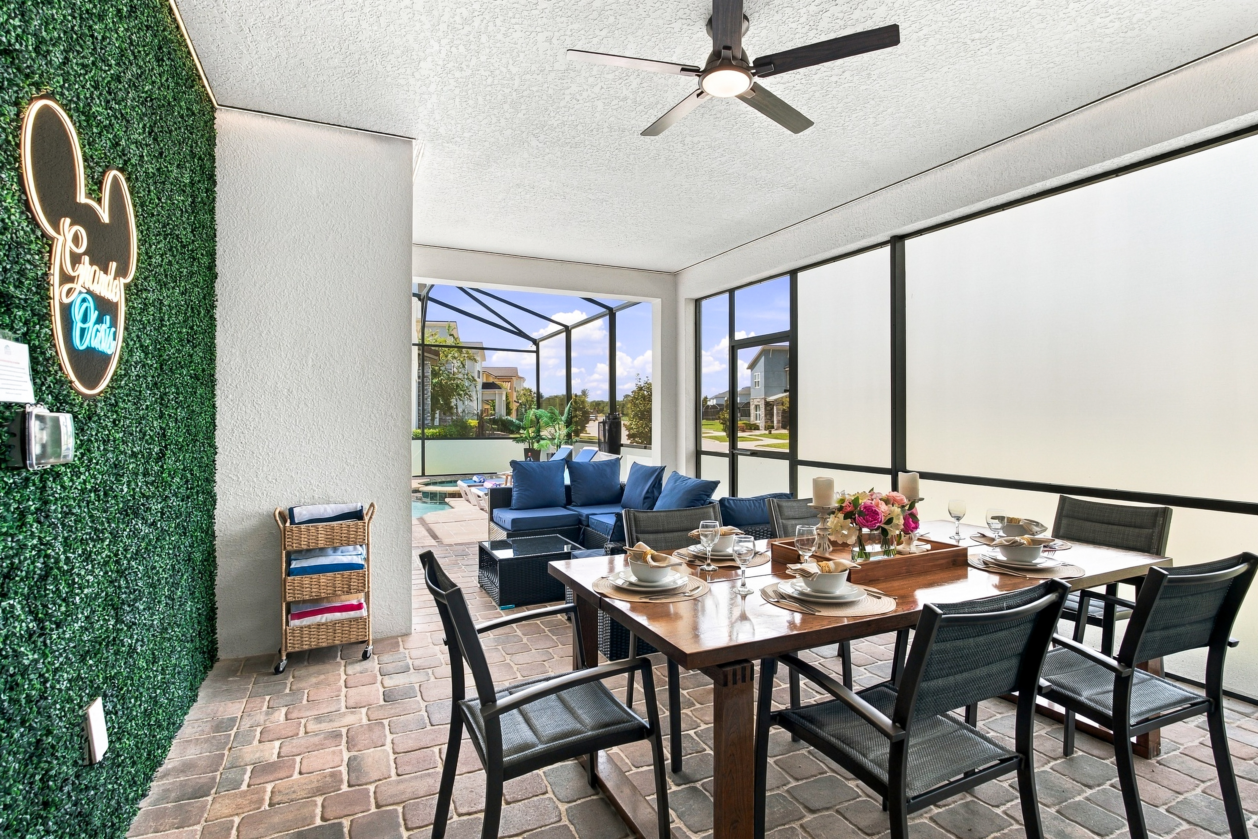 Covered patio dining with lounge seating and screened pool access