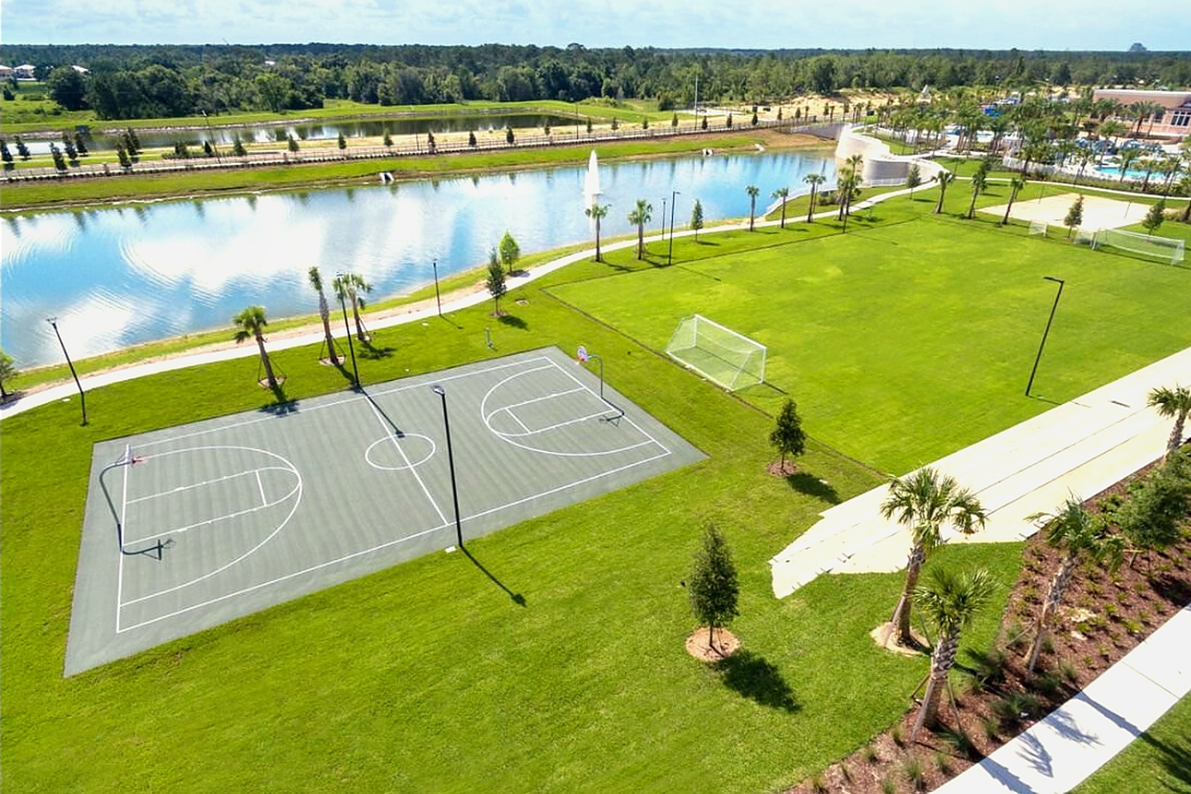 Lakefront sports courts and open green space with resort-style views
