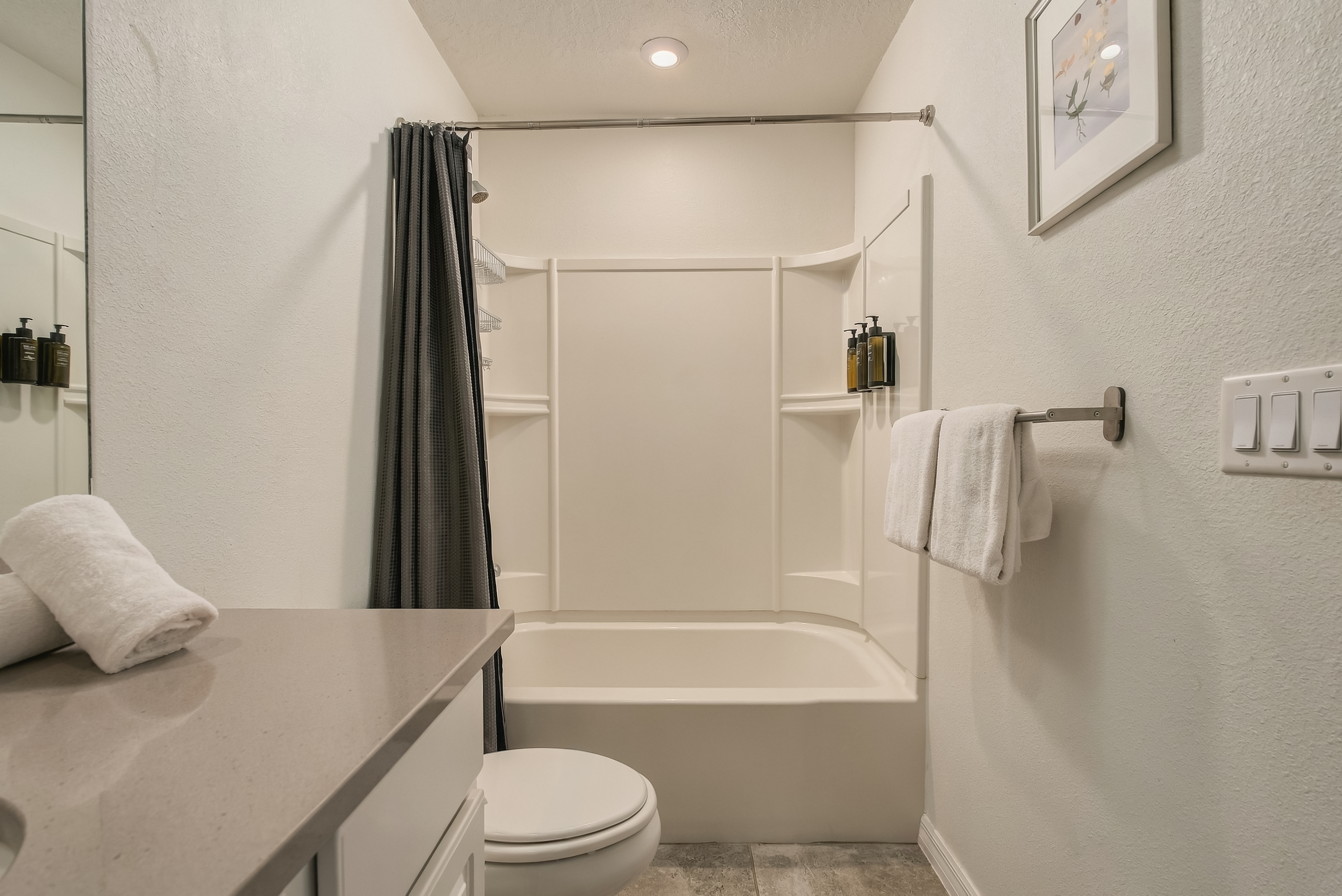 Bright, modern bathroom with tub-shower combo and clean finishes