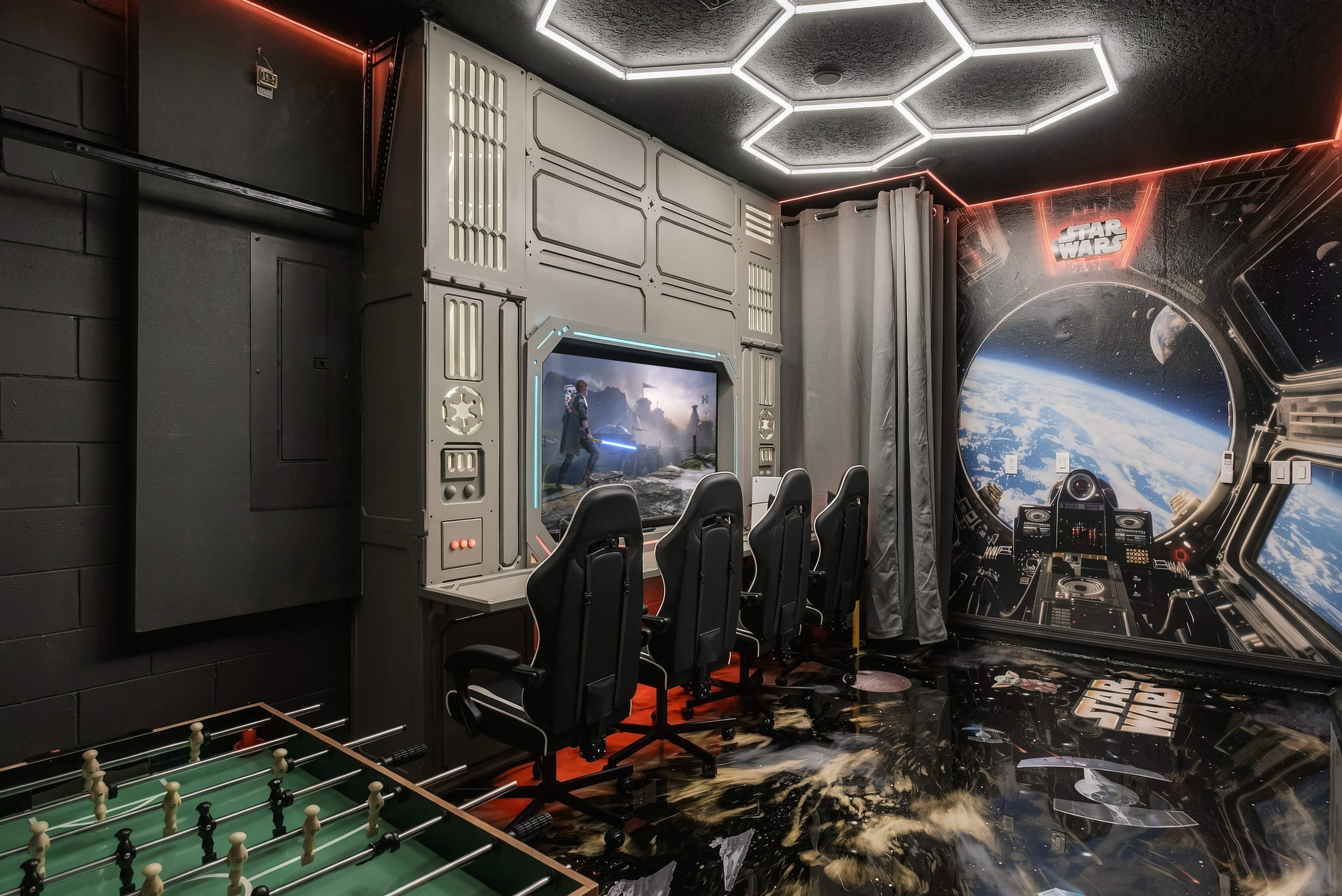 The Star Wars galaxy game room  with immersive hex lighting, 4 gaming chairs, a PS5, foosball, and its own mini-split A/C. Comfortable even in the Florida heat.