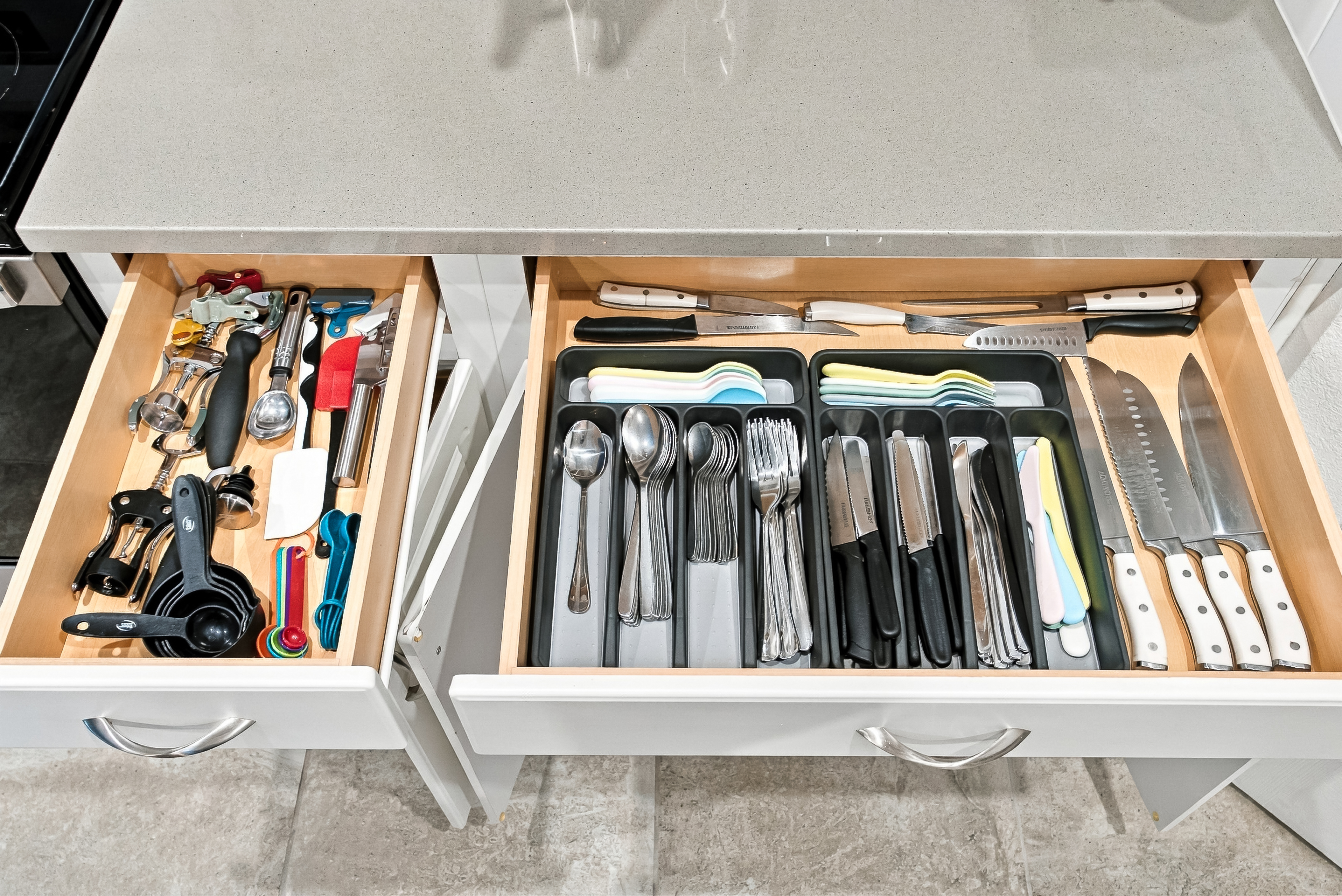 Well-stocked kitchen drawers with organized utensils and cooking essentials