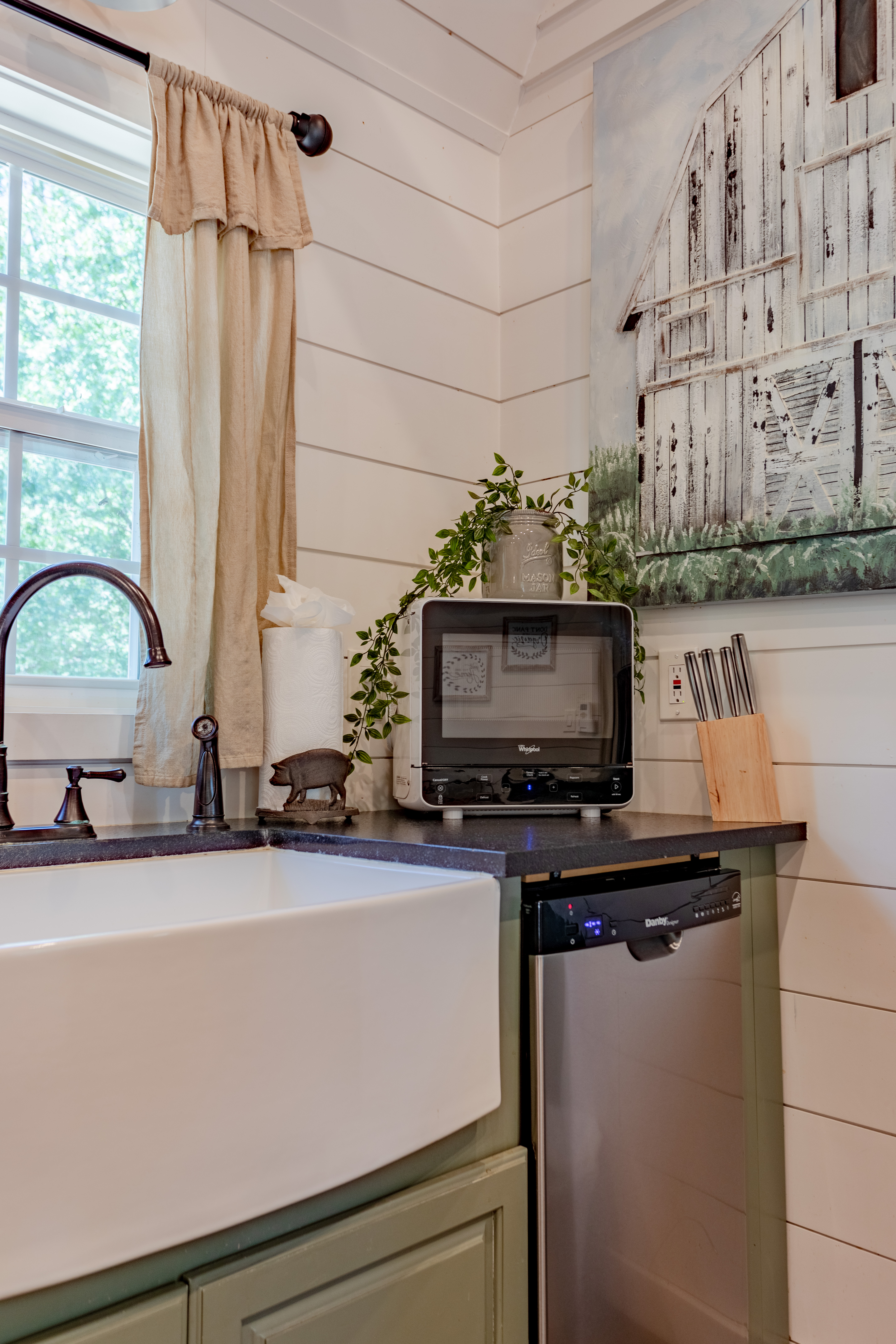 Charming farmhouse kitchen with deep sink, dishwasher, and rustic style