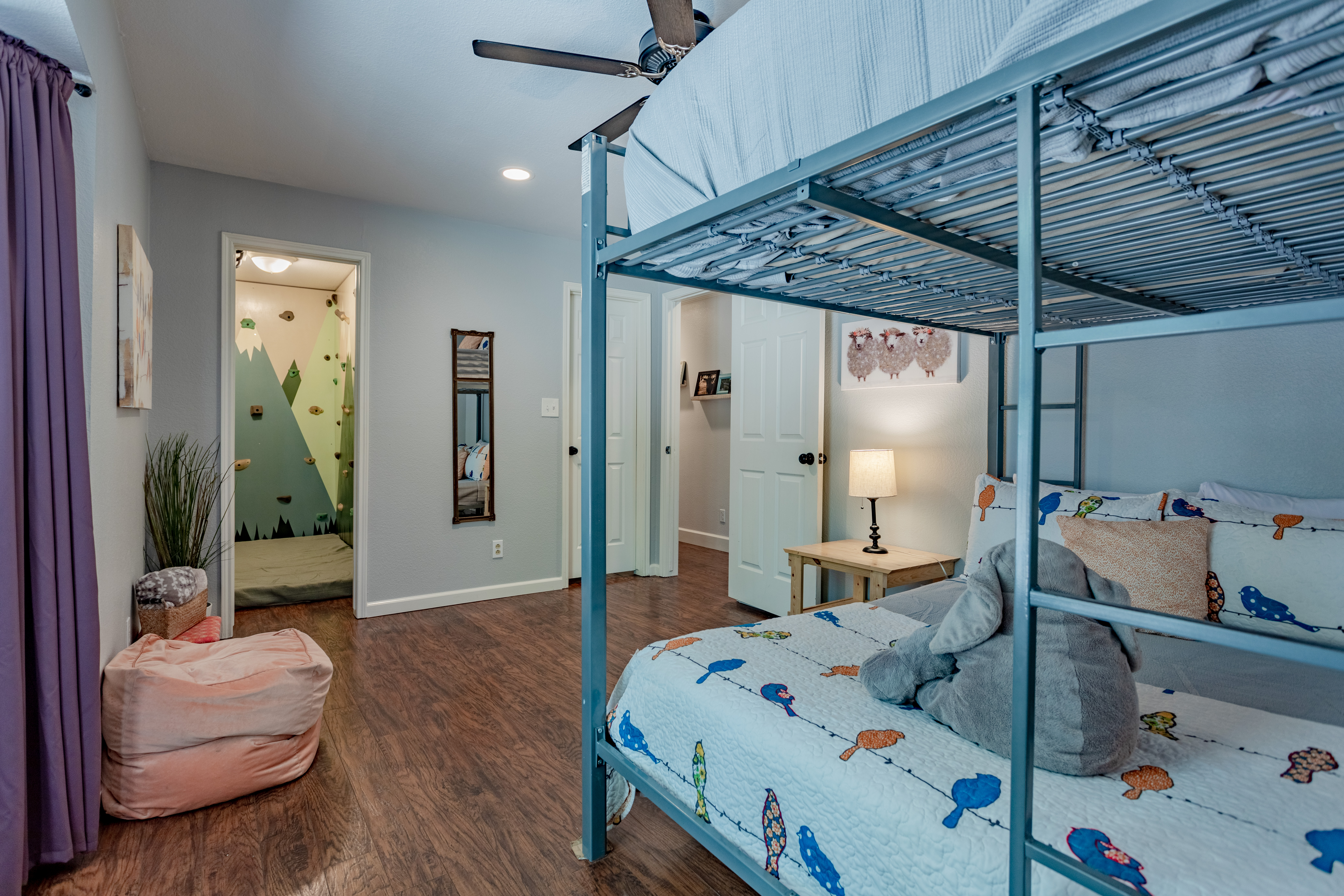 Fun bunk room with playful décor and easy access to the bathroom