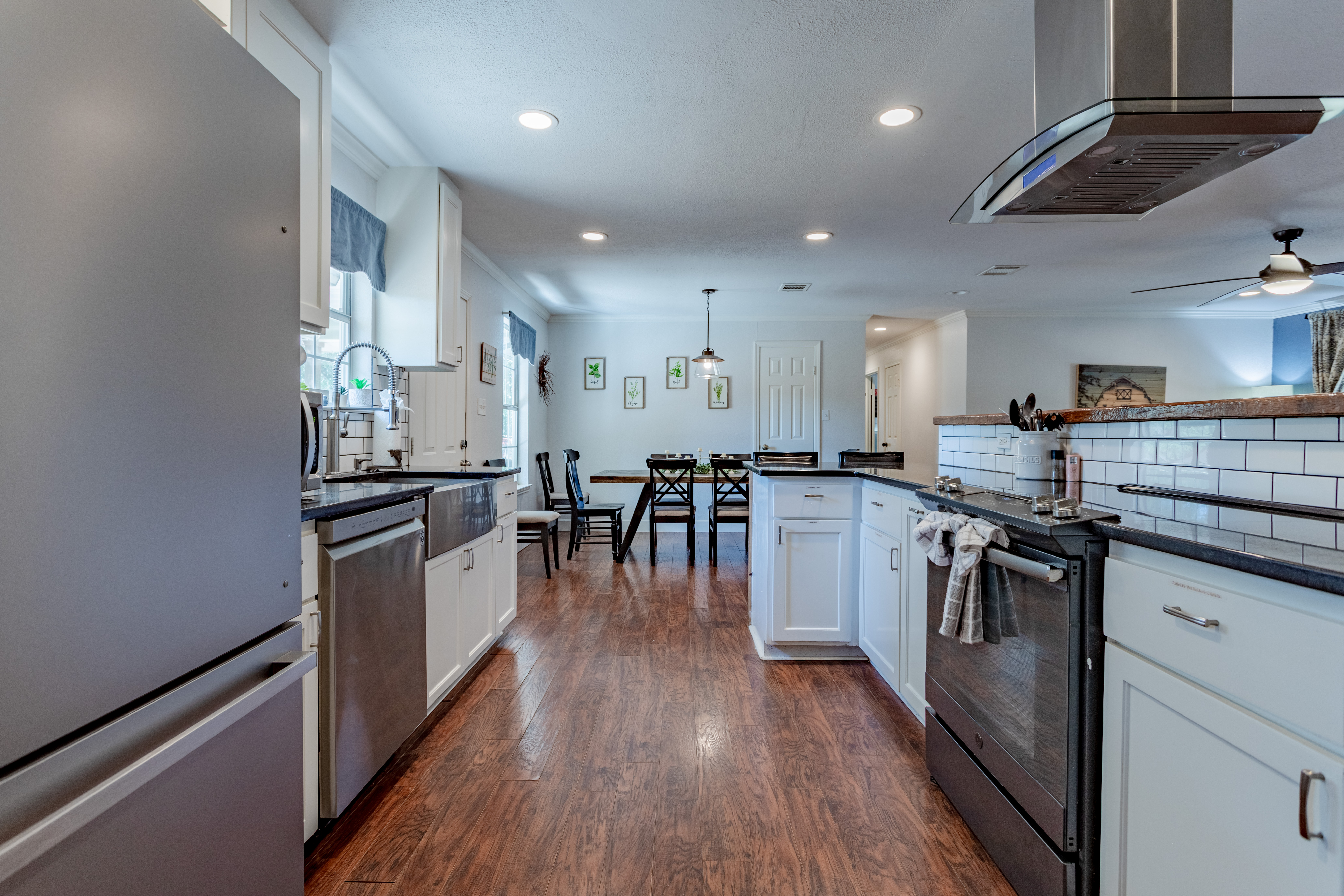 Bright modern kitchen with stainless appliances and dining space