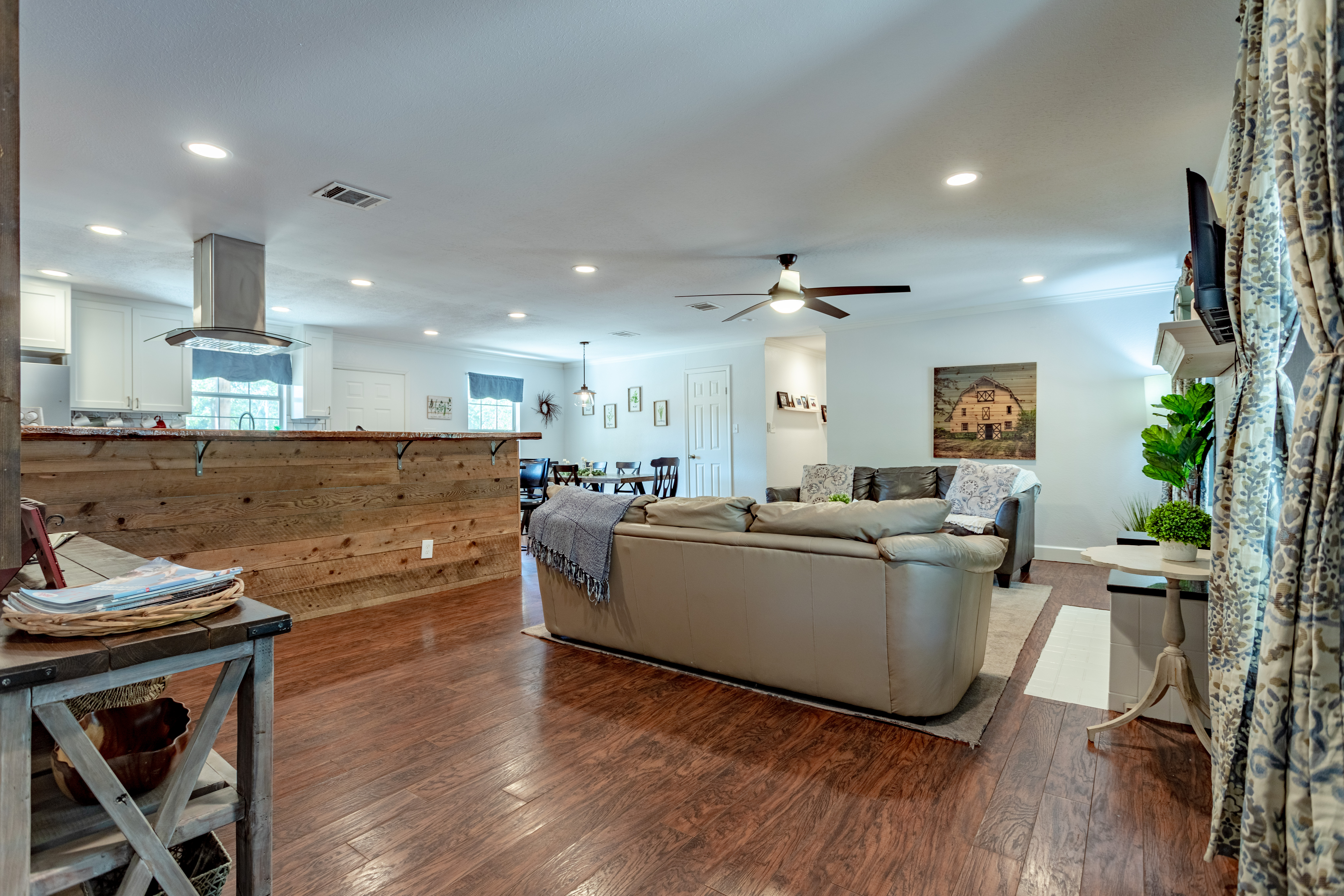 Bright open-concept living space with cozy seating and rustic charm
