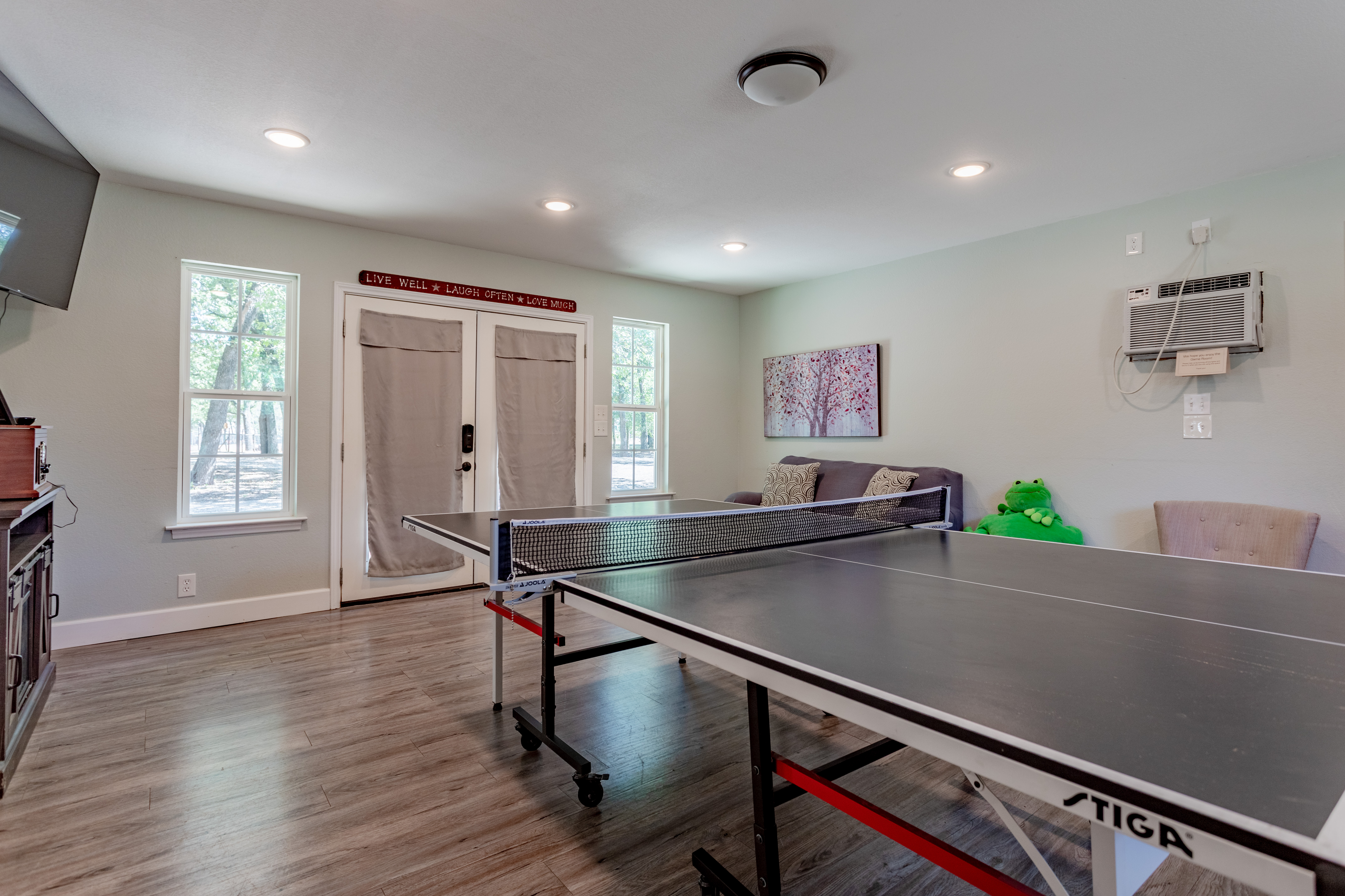 Bright game room with ping pong, lounge seating, and natural light