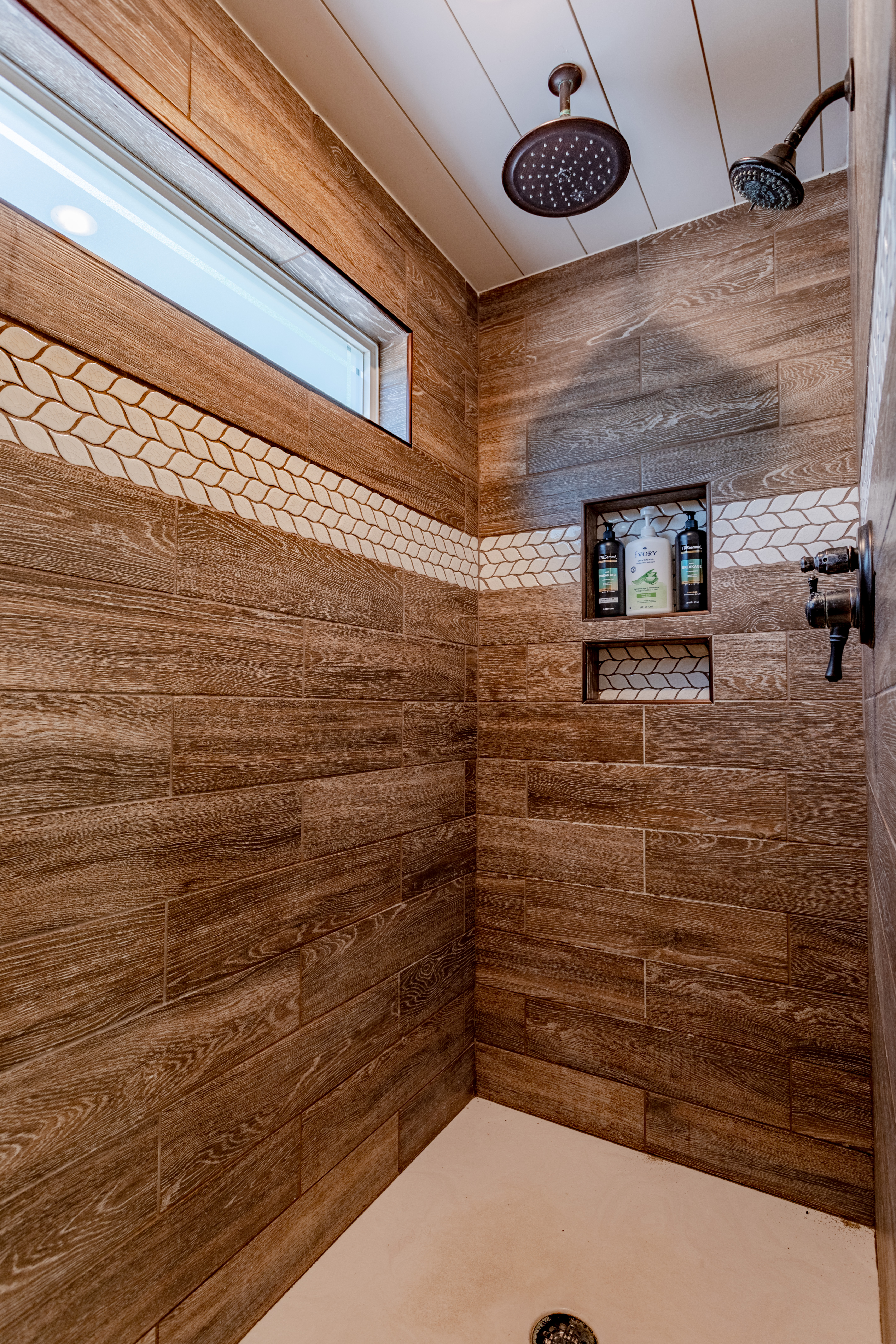 Spa-style walk-in shower with dual showerheads and designer tile