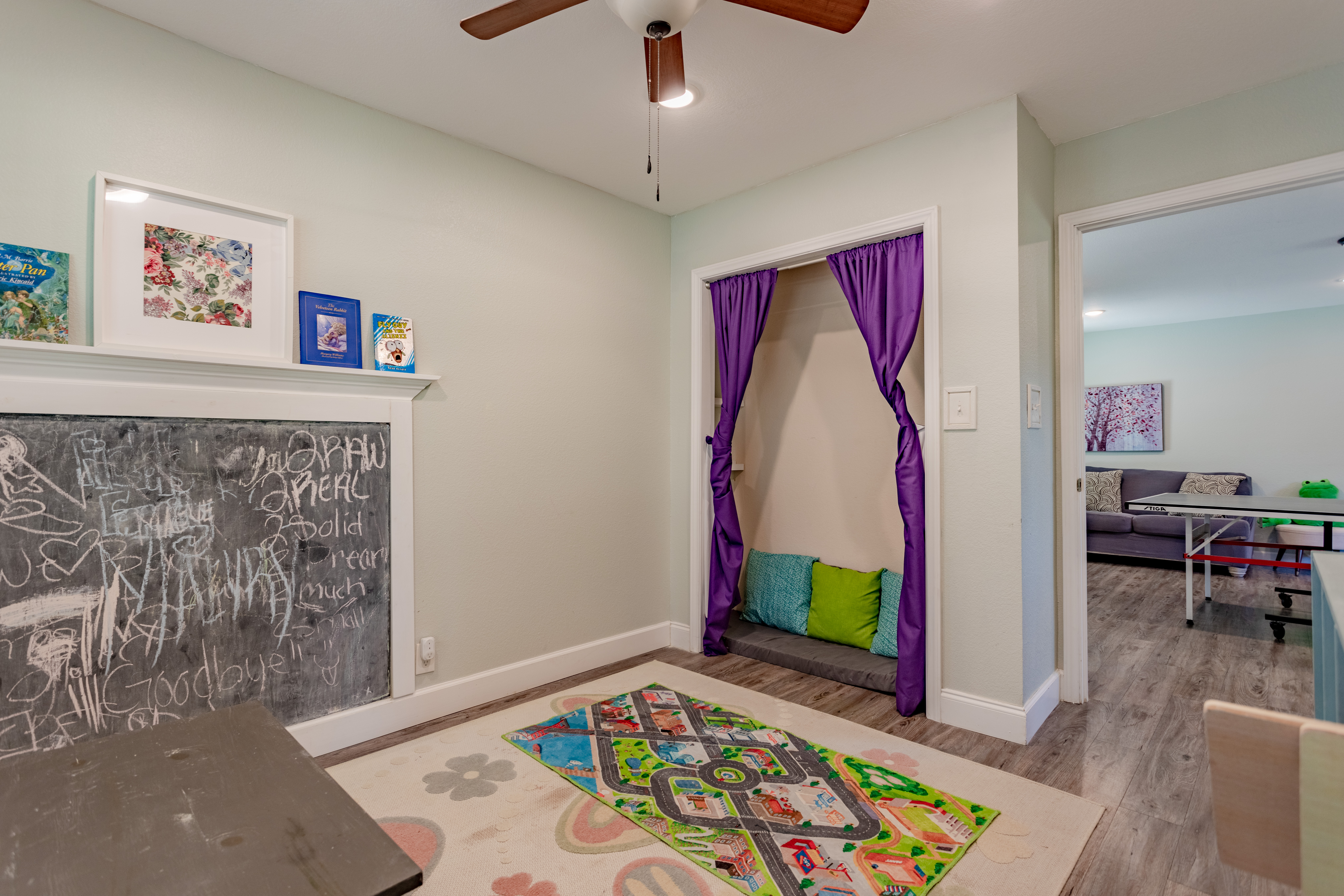 Bright kids’ playroom with chalkboard wall and cozy reading nook