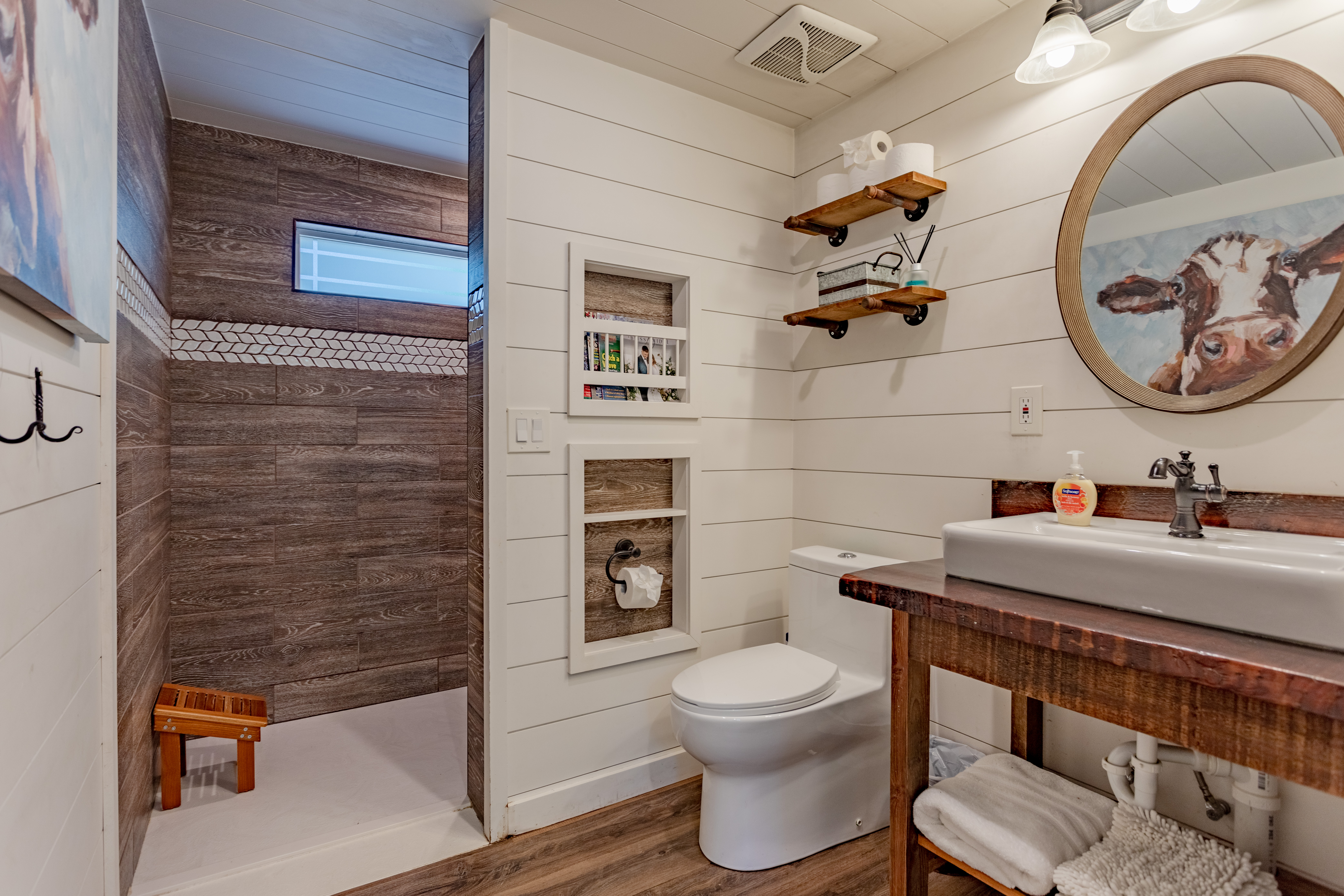 Bright farmhouse bathroom with walk-in shower and rustic vanity charm