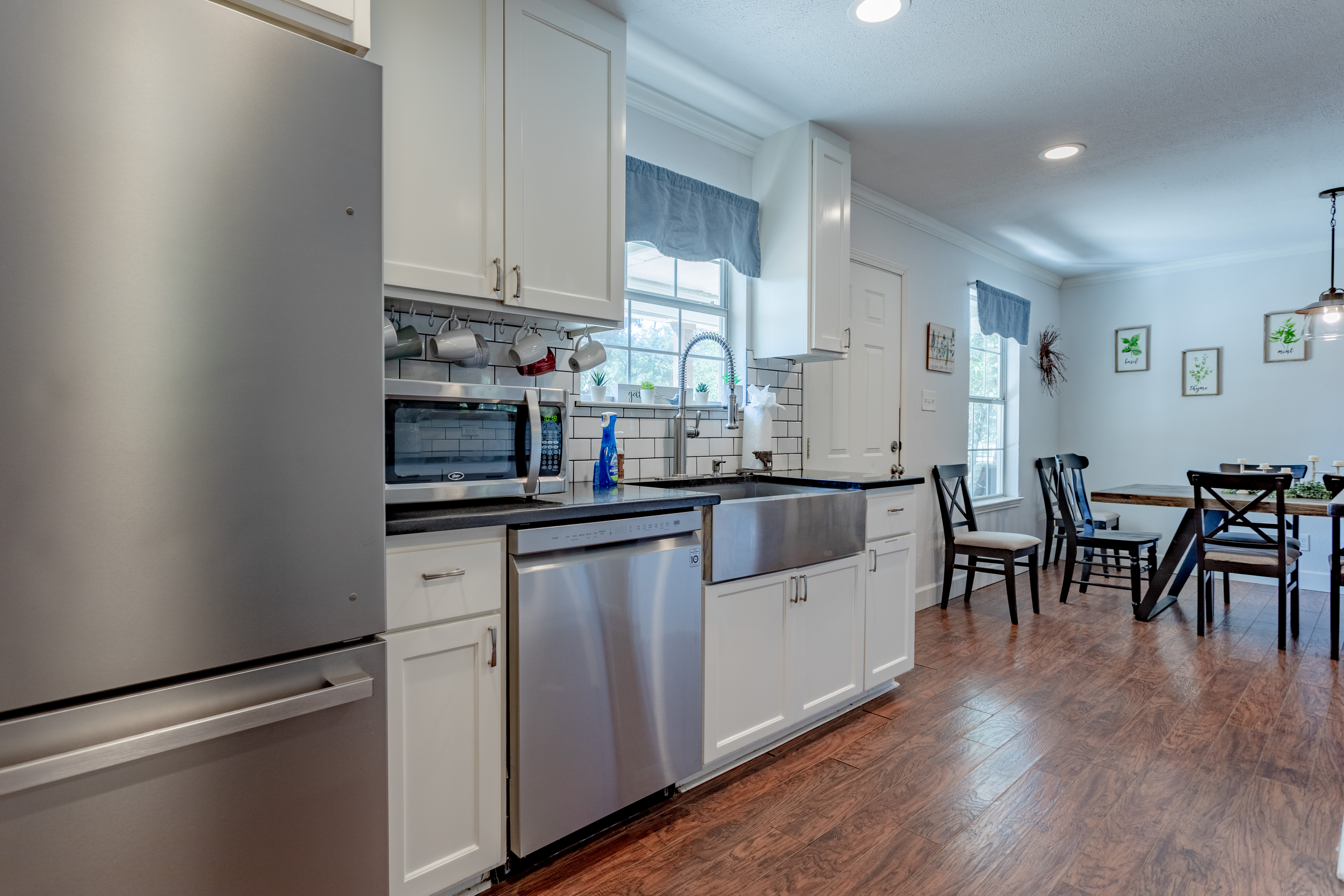 Bright open kitchen with farmhouse sink and inviting dining space