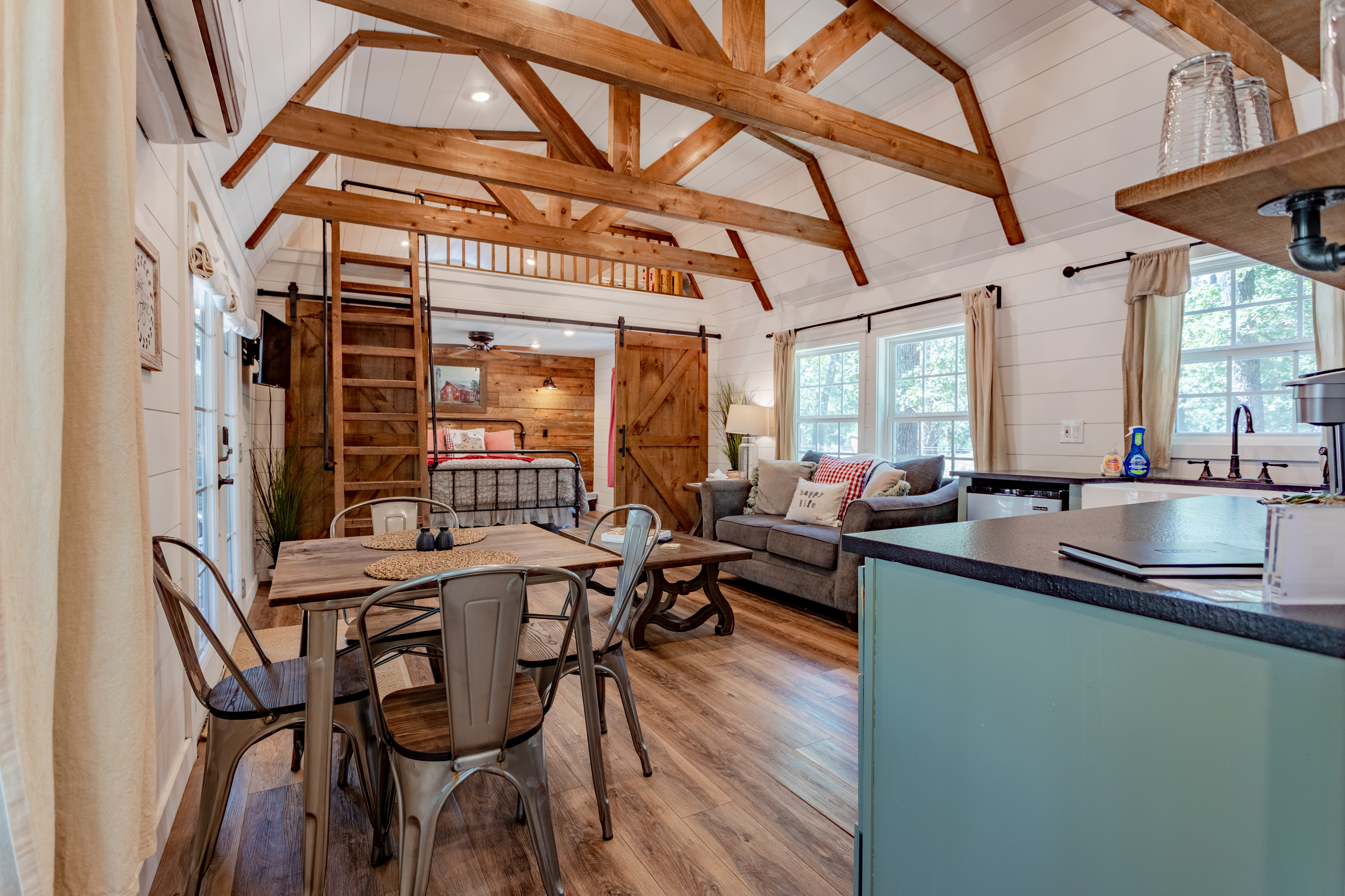 Bright rustic cabin with vaulted ceilings, loft bedroom, and cozy open living