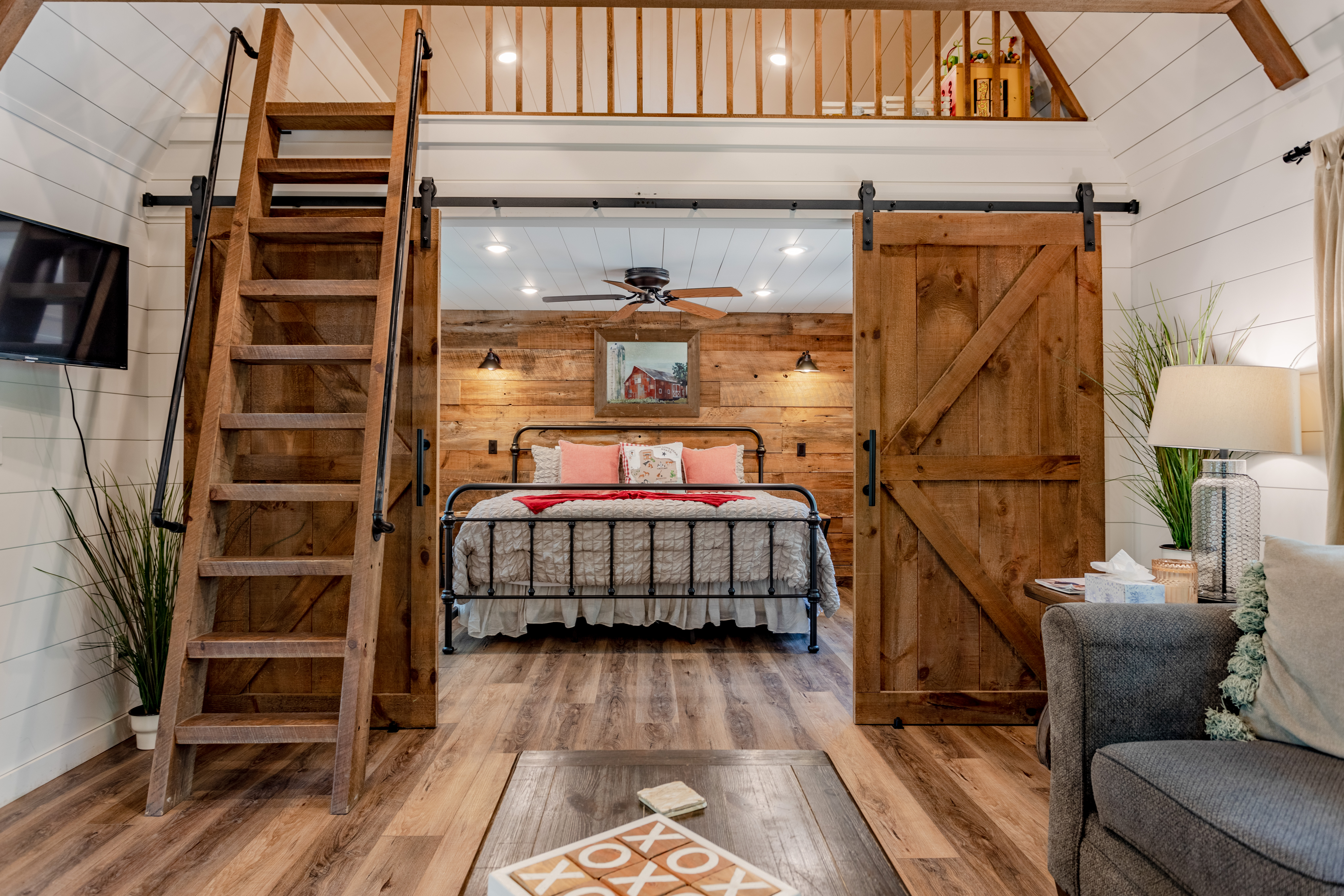 Rustic cabin retreat with loft, barn doors, and cozy modern charm