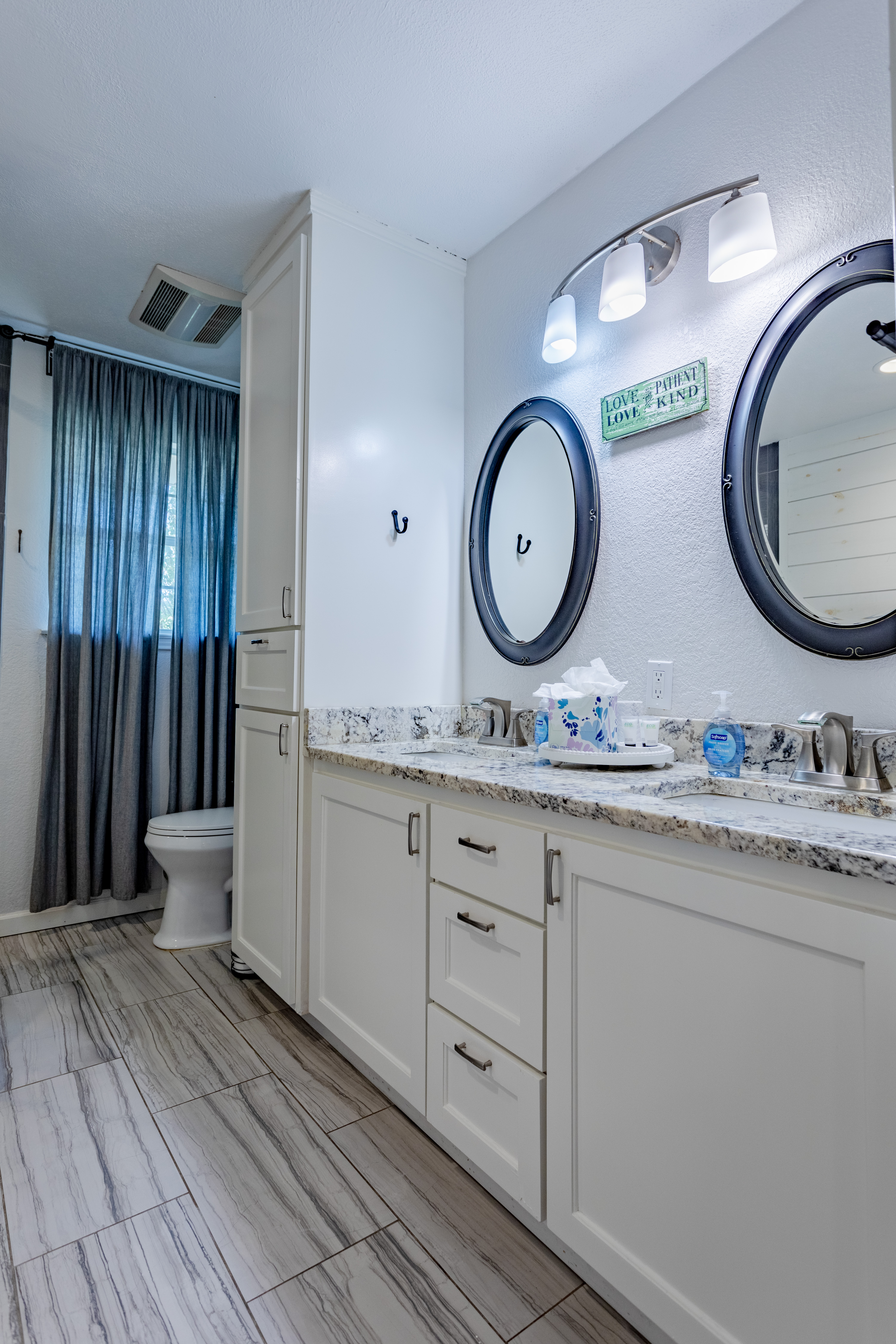 Bright updated bathroom with double vanity, stylish finishes, and ample storage