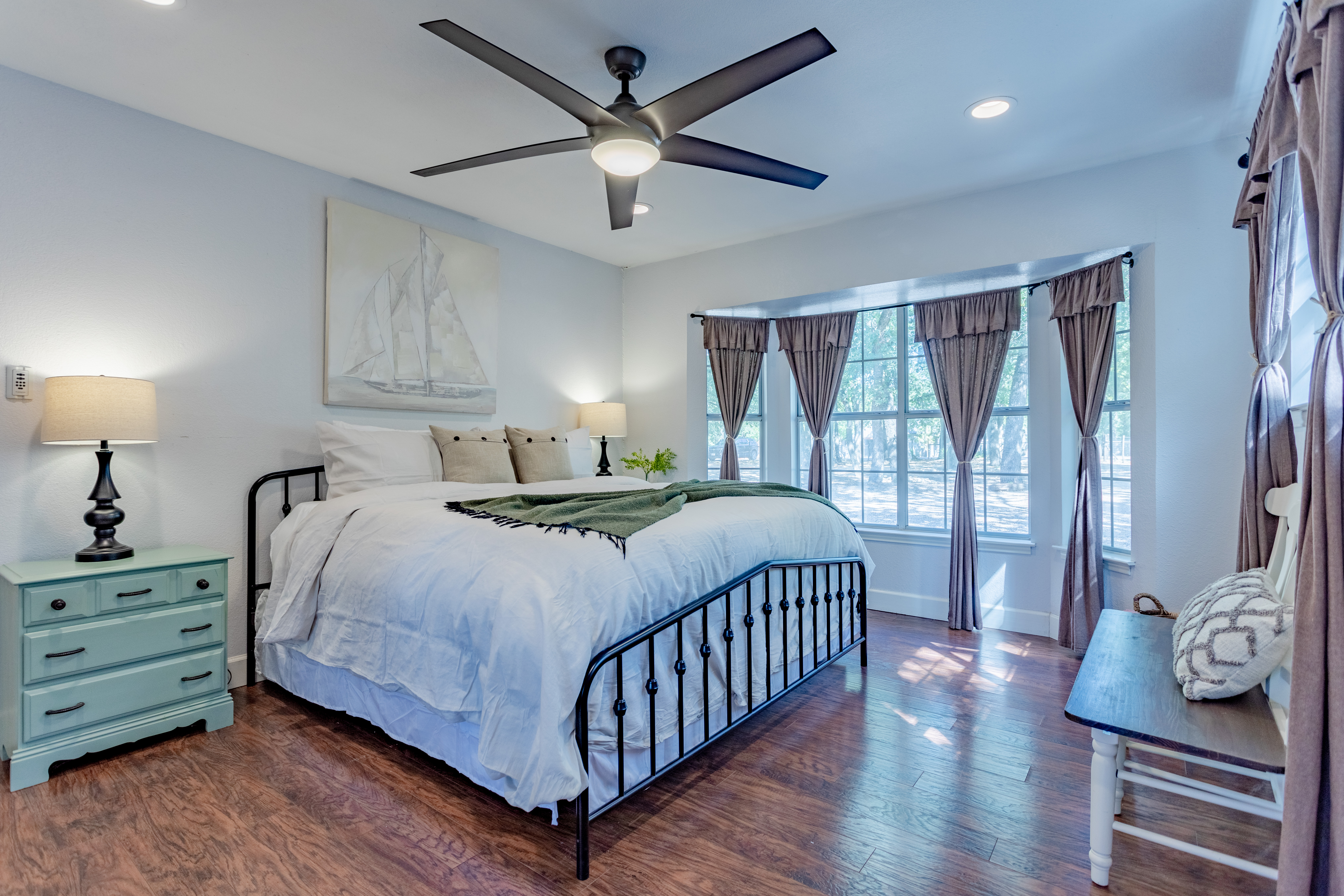 Bright, airy bedroom with king bed, large windows, and elegant touches