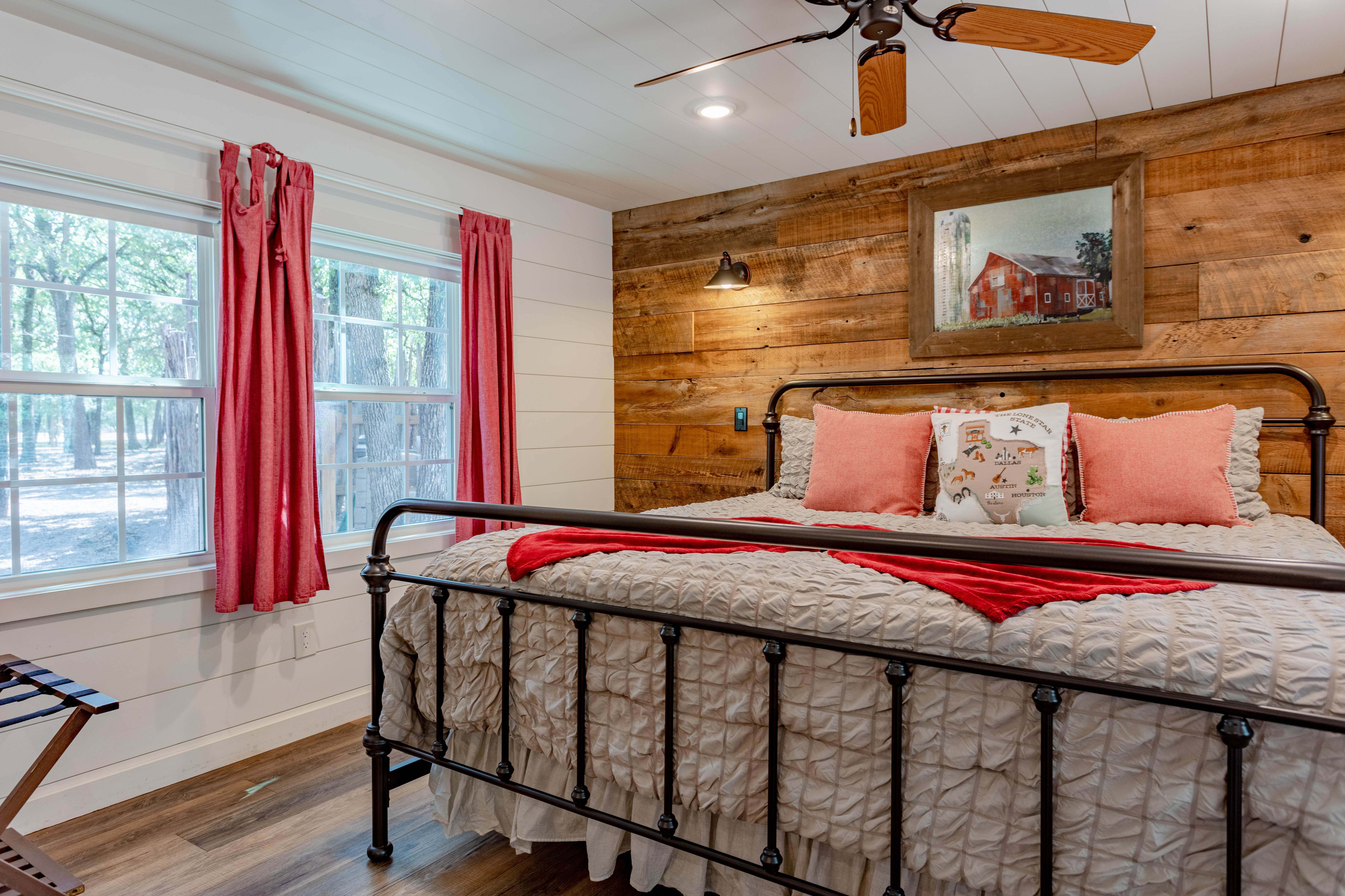 Cozy farmhouse bedroom with king bed and peaceful wooded views
