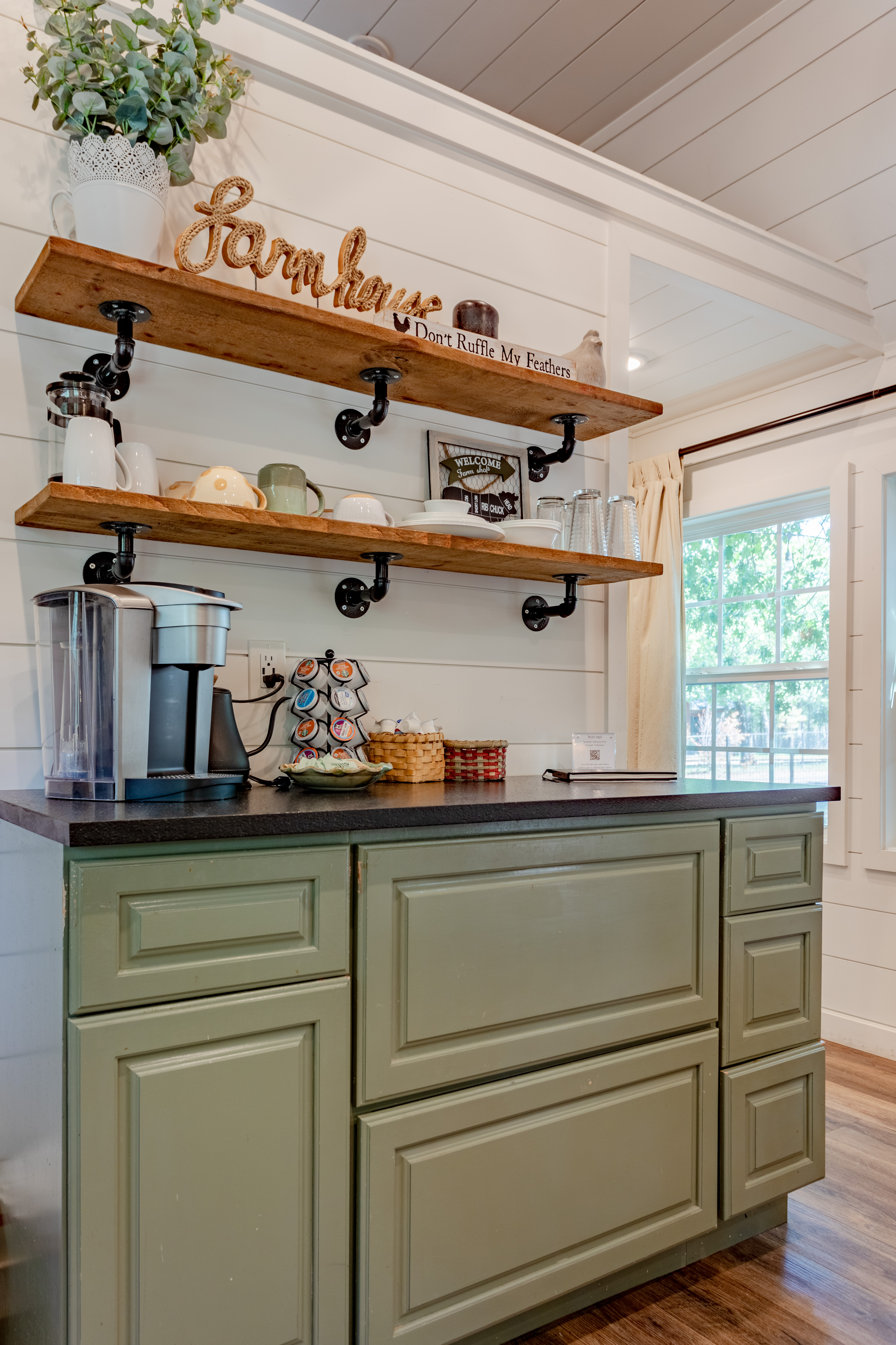 Cozy farmhouse-style coffee bar with open shelving and guest-ready setup