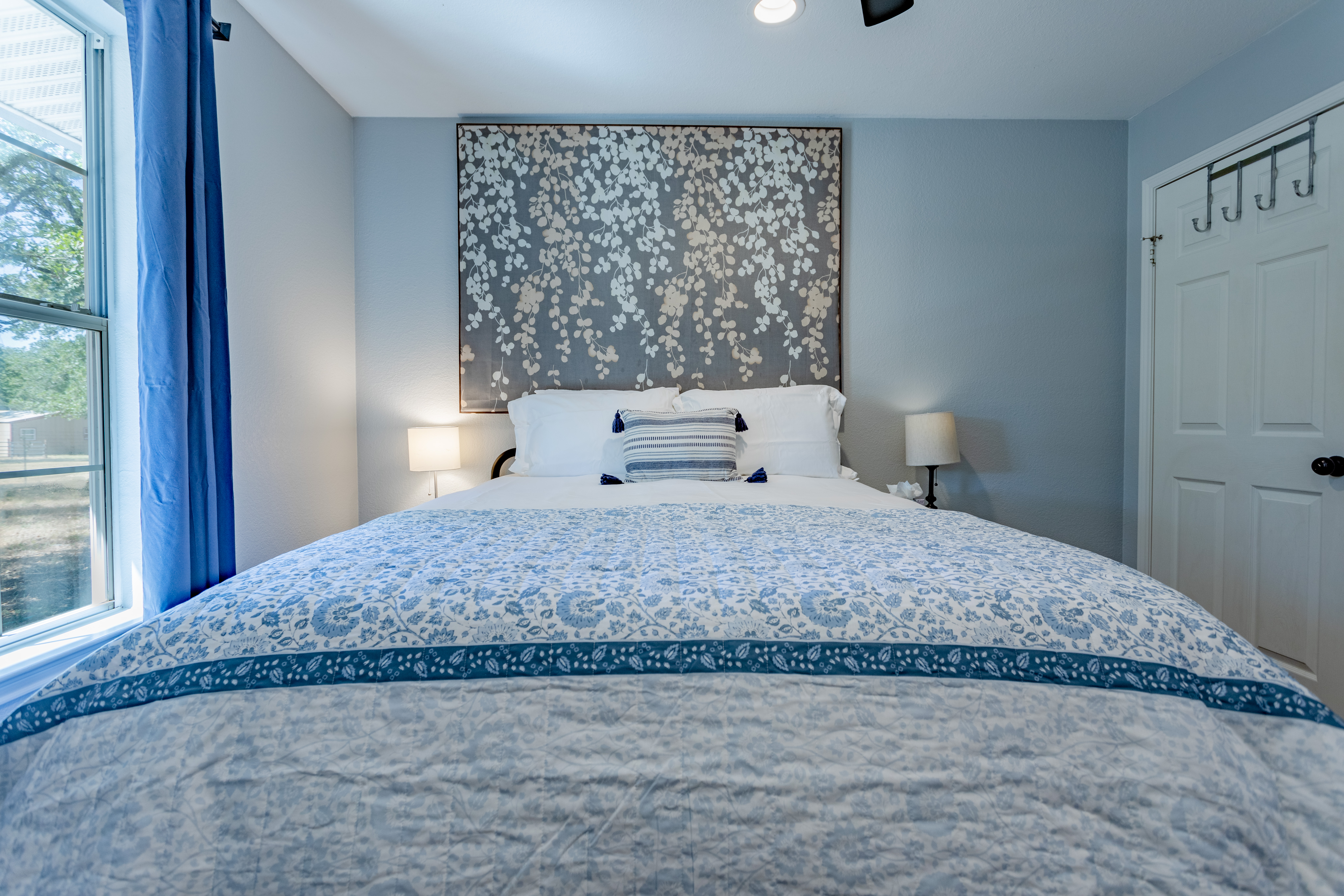 Bright, cozy bedroom with plush bedding and calming blue accents