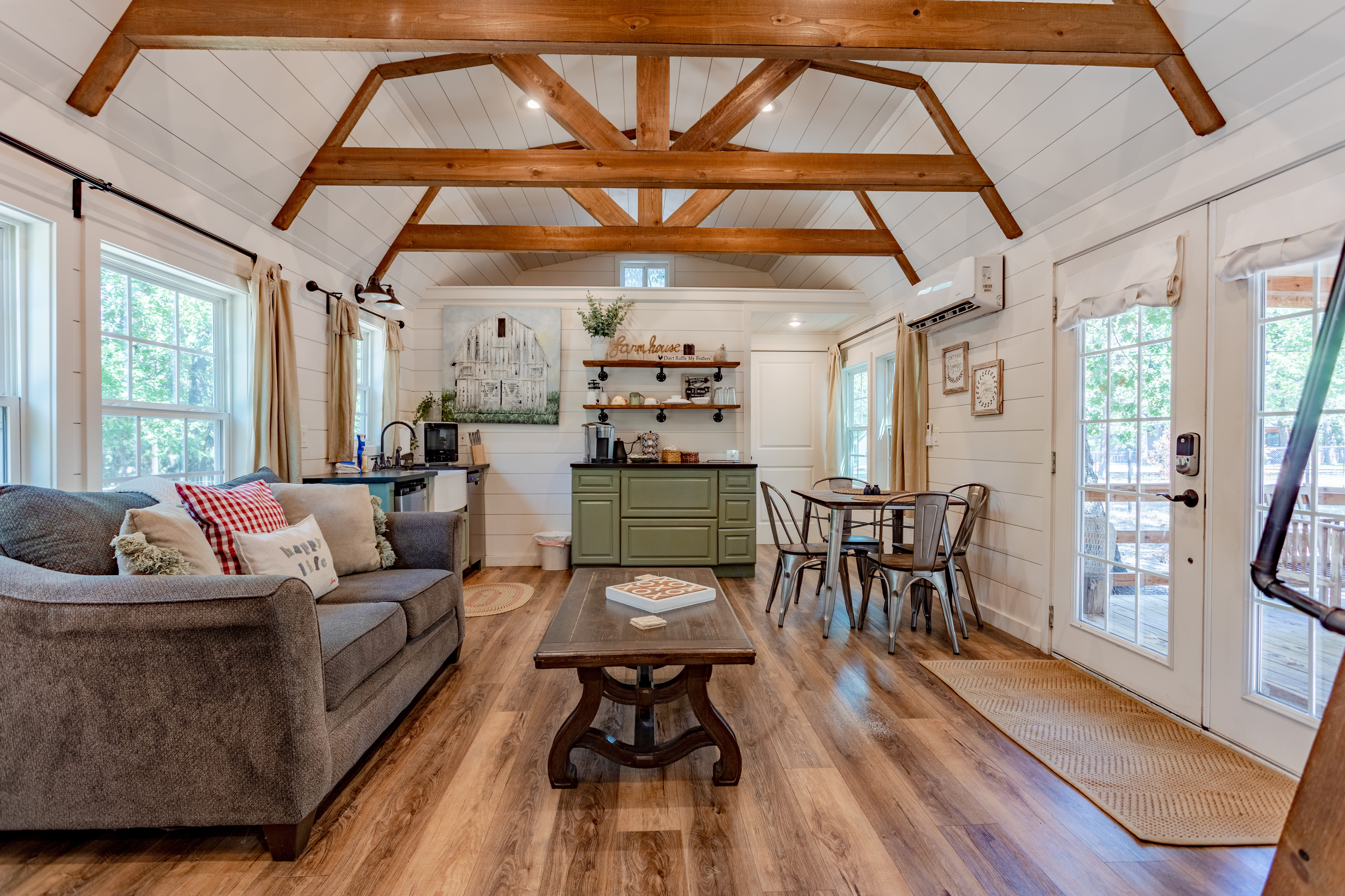 Bright farmhouse-style living space with vaulted ceilings and rustic charm