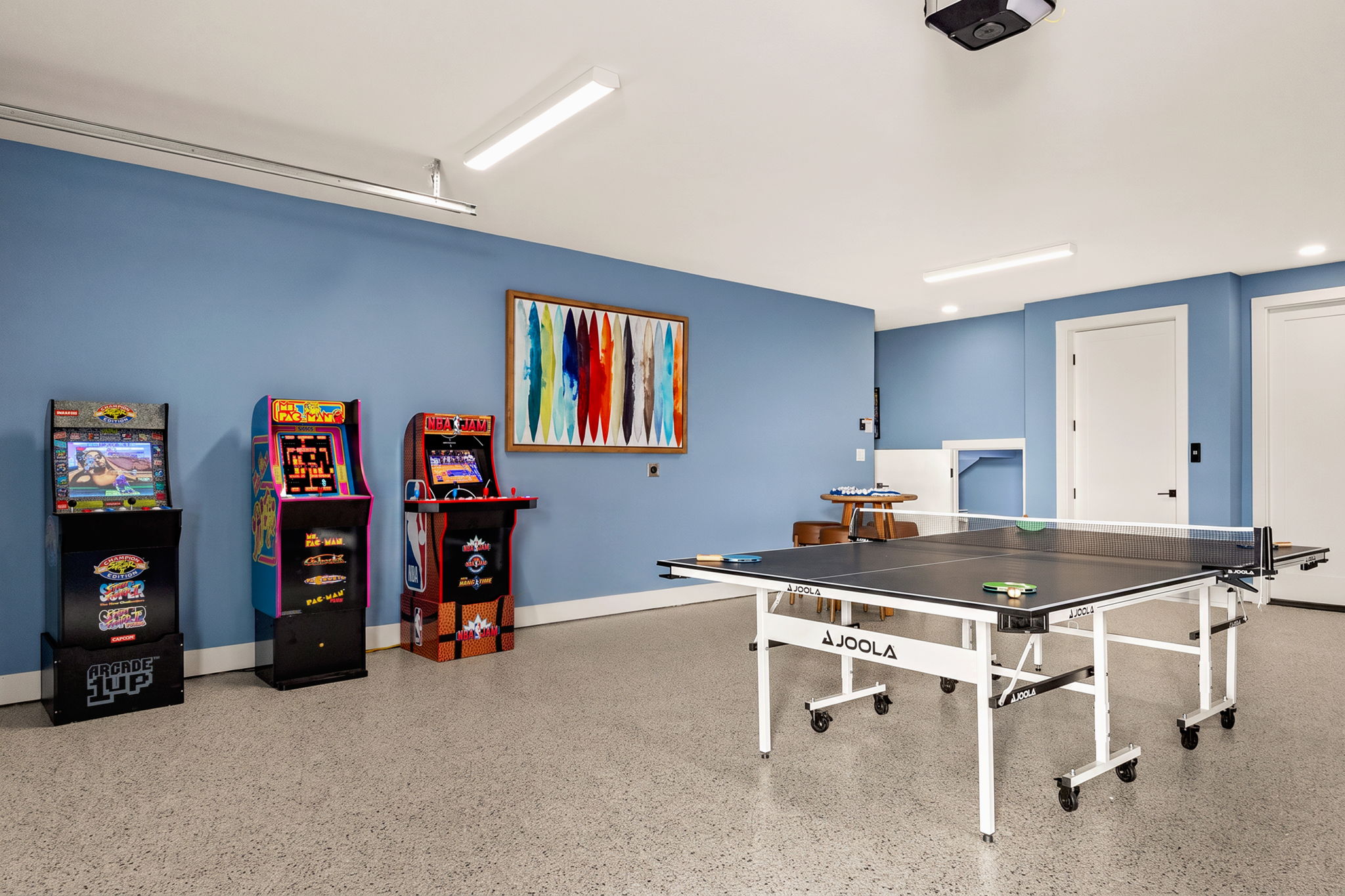 Highland Haven game room with arcade cabinets and ping pong