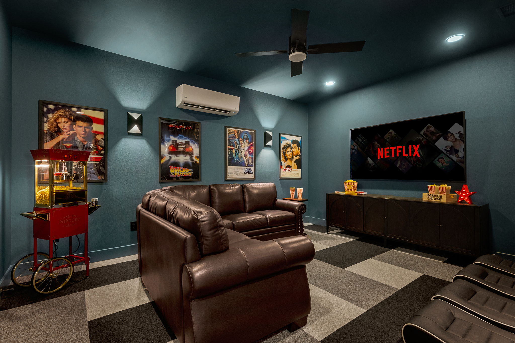 Highland Haven private media room with recliners and popcorn machine