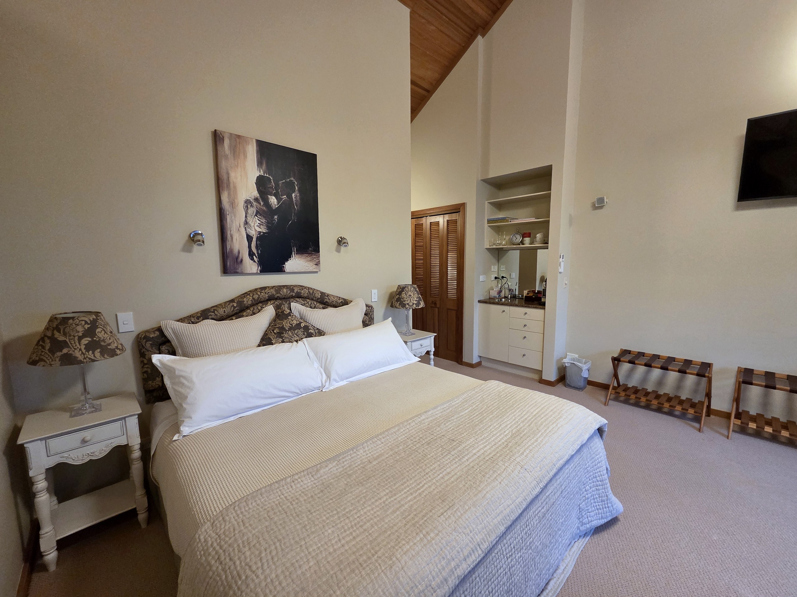 Balcony Super King Suite bed with the kitchenette and Nespresso nook