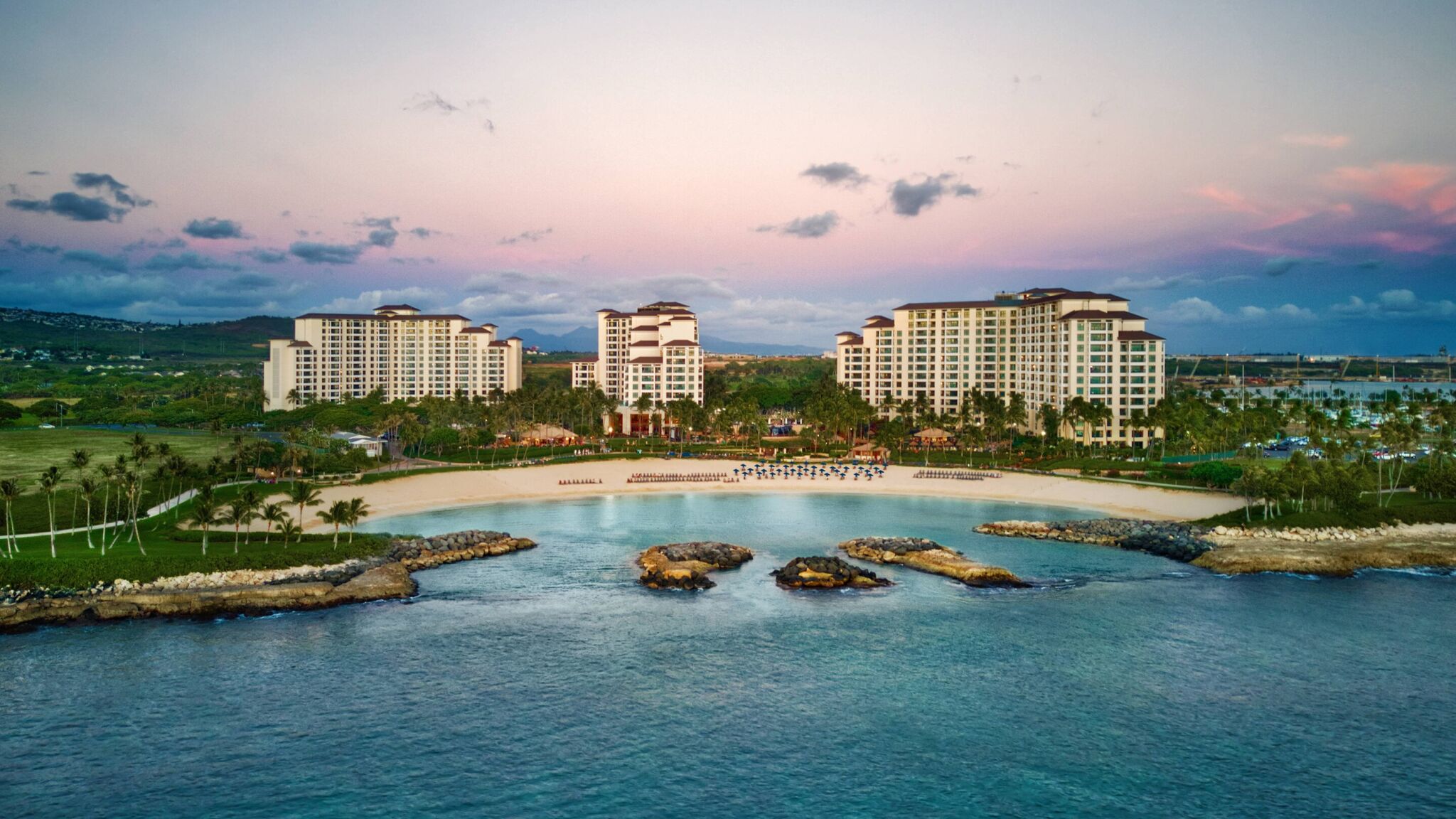 Stunning beachfront resort with a serene lagoon at sunset