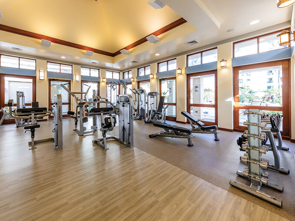 Bright, well-equipped fitness center with natural light and ample space