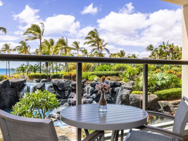Private tropical lanai with waterfall views and a peek of the ocean