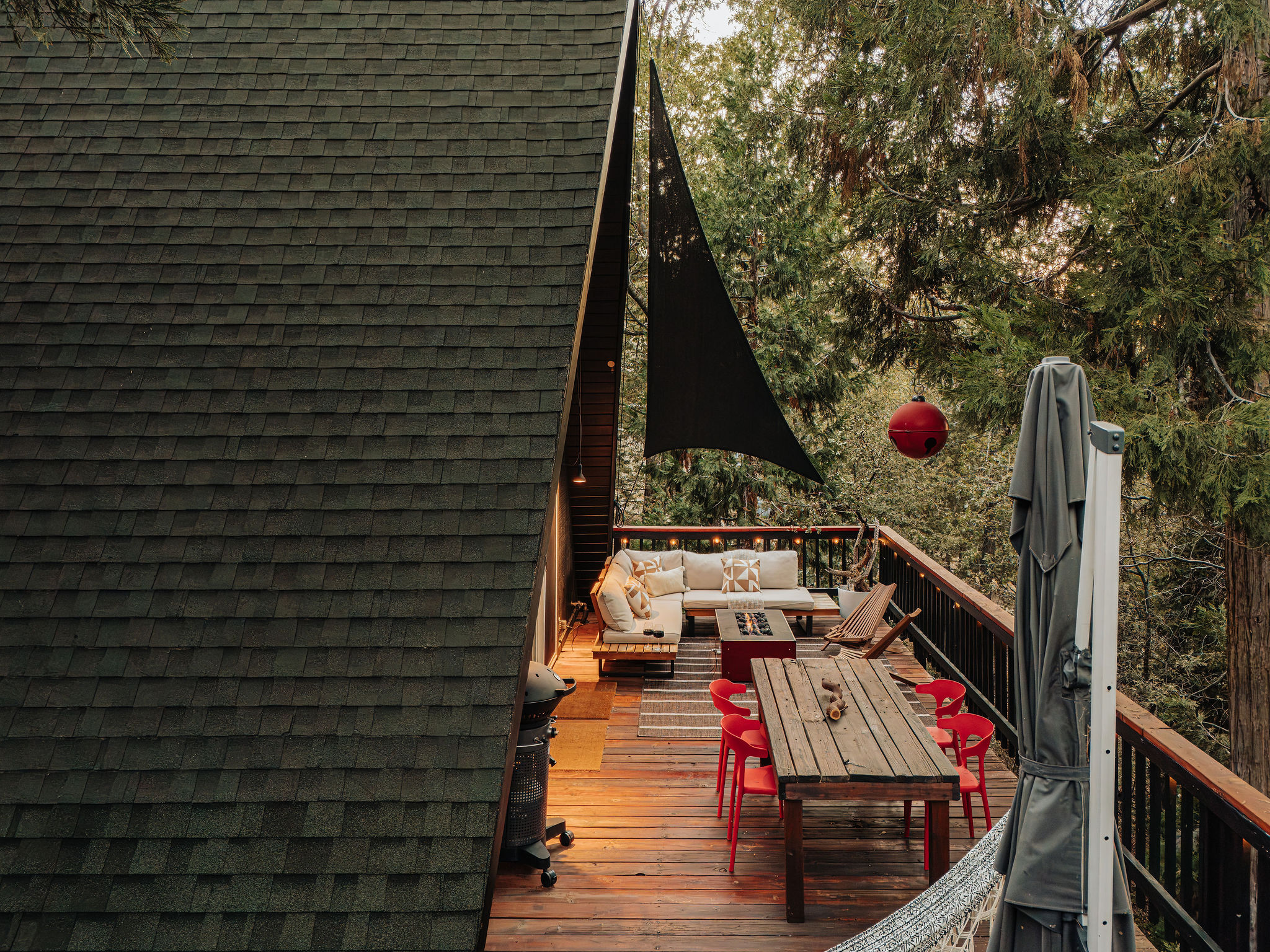 Private forest-view deck with outdoor dining and cozy lounge seating