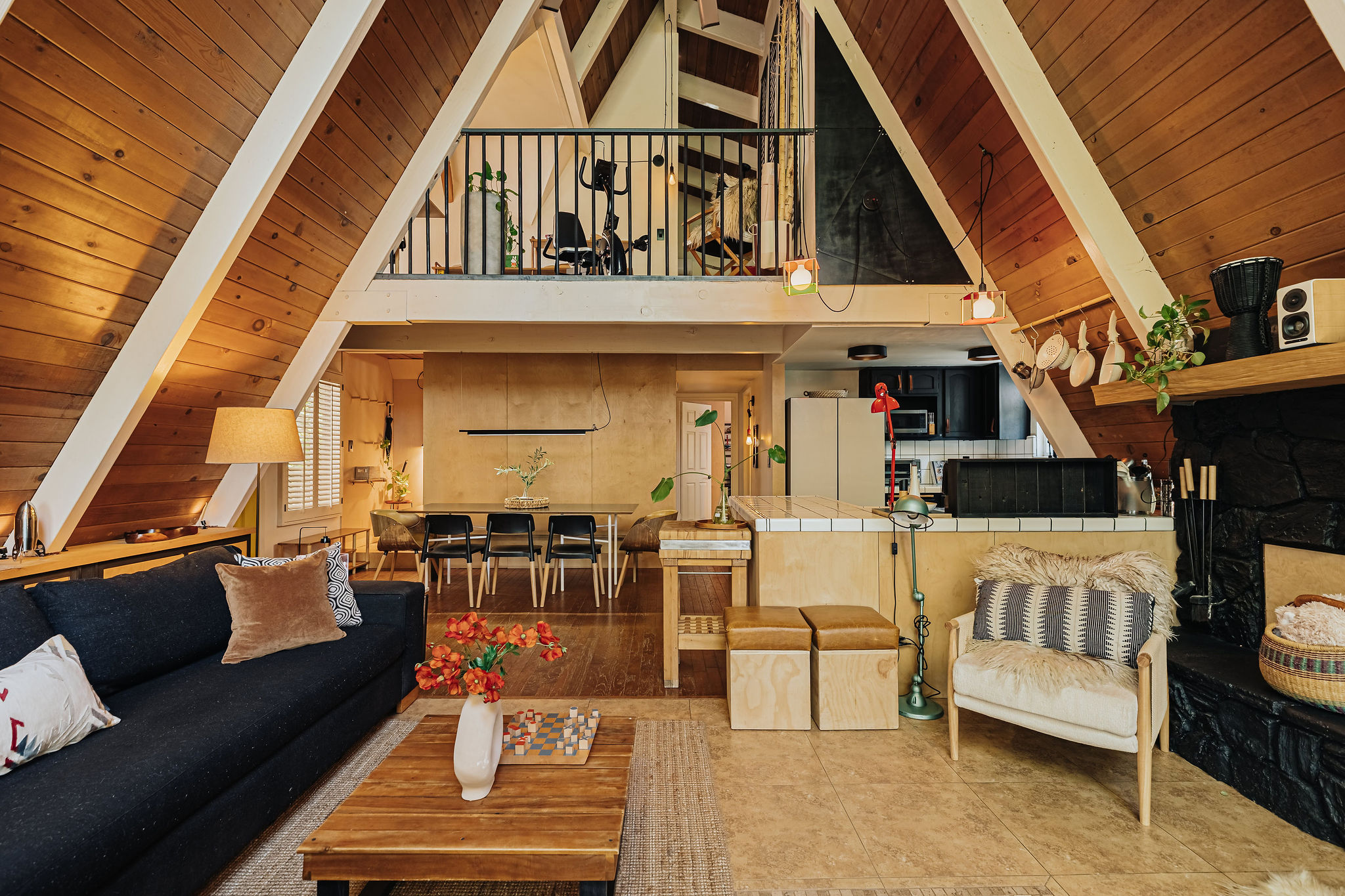 Cozy A-frame retreat with loft, warm wood interiors, and open living space