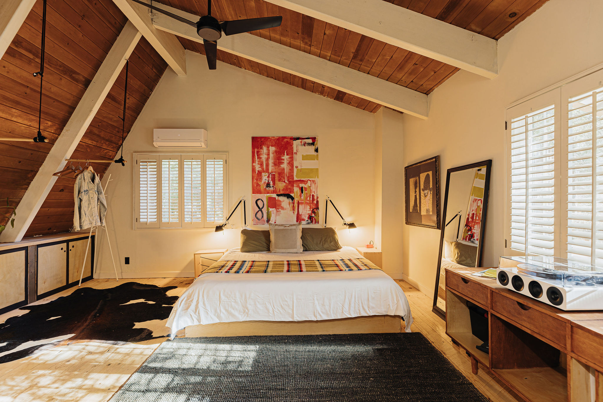 Vaulted wood ceilings and a stylish king bedroom retreat