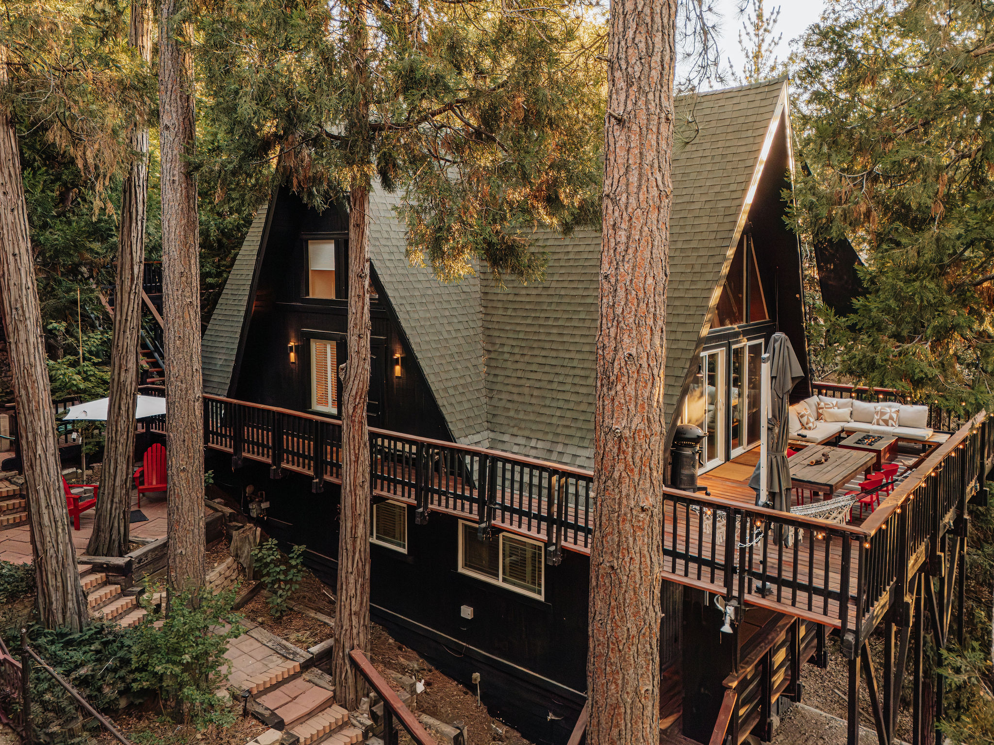 Secluded A-frame cabin with spacious forest-view deck and lounge seating