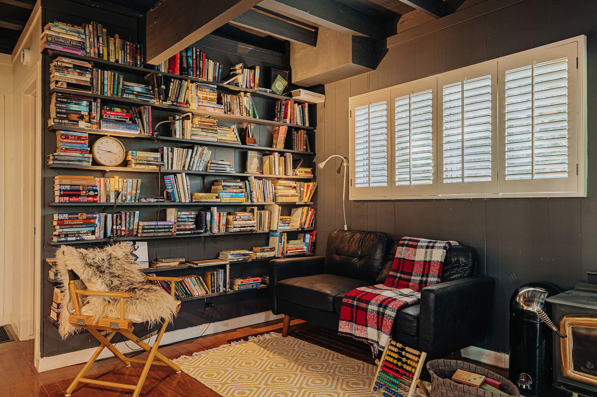 Cozy library nook with built-in bookshelves and comfy seating