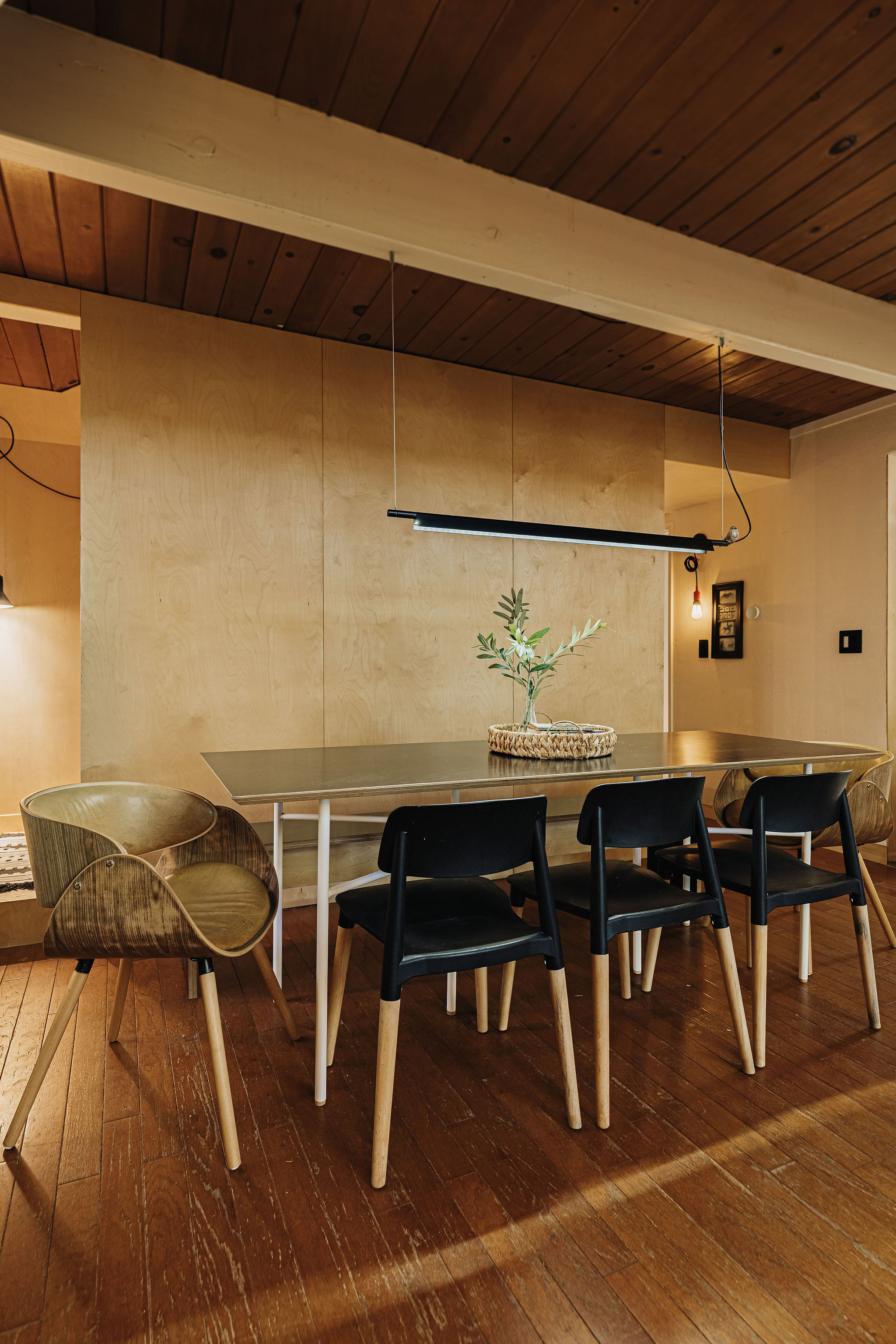 Modern dining space with warm wood accents and seating for five