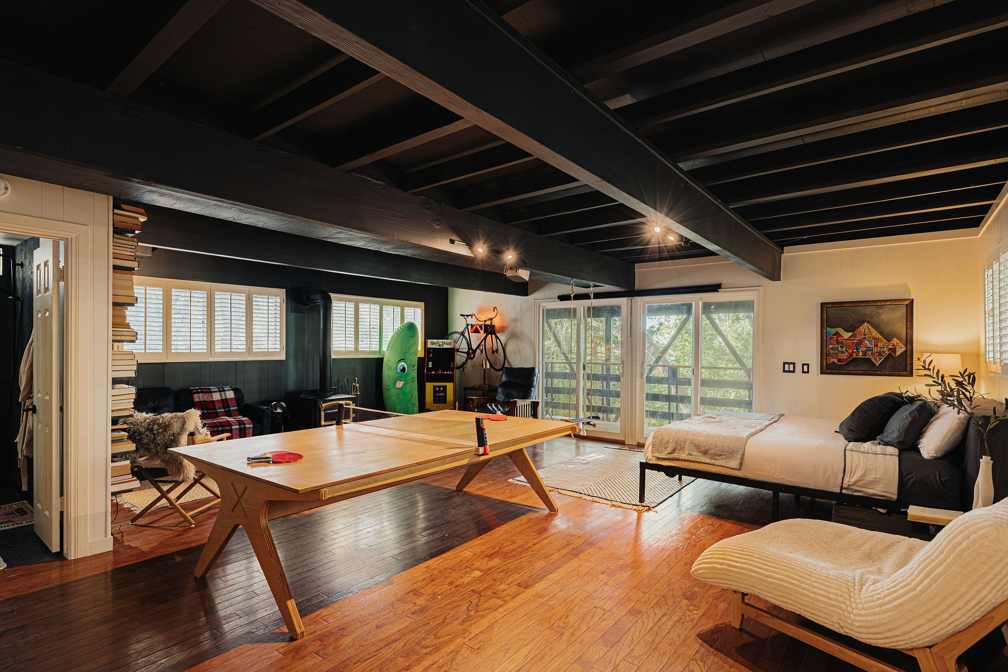 Spacious loft-style retreat with ping pong, deck access, and warm wood details