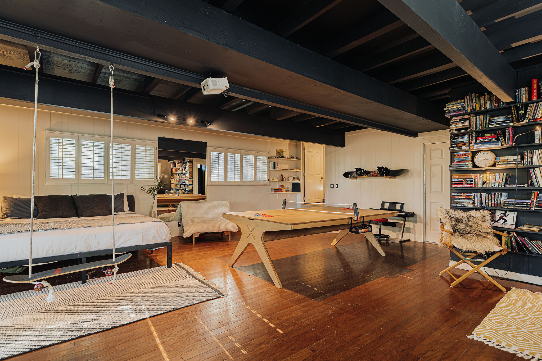 Loft-style suite with indoor swing, game table, and warm wood accents