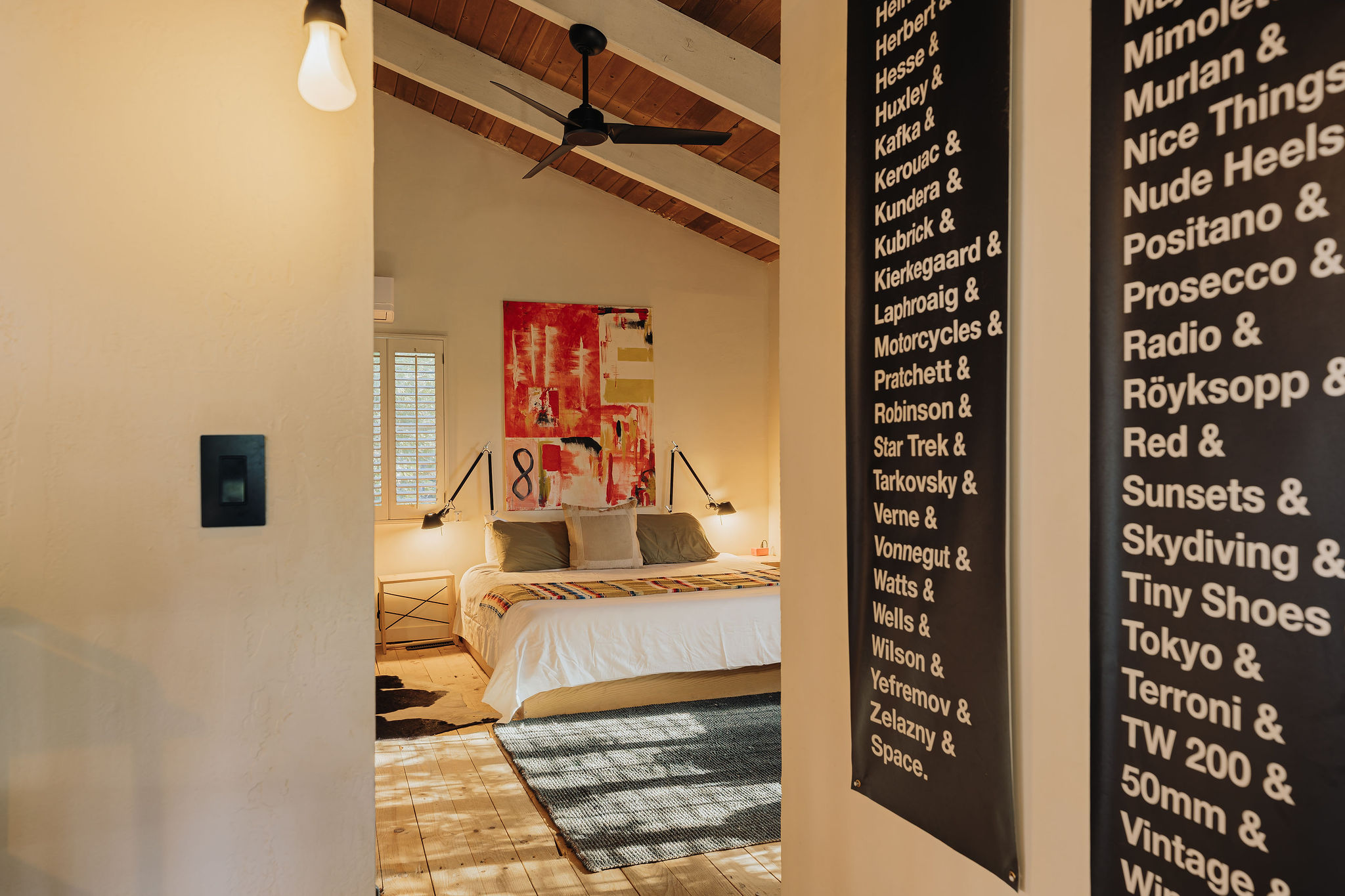Bright designer bedroom with vaulted ceilings and modern artistic flair