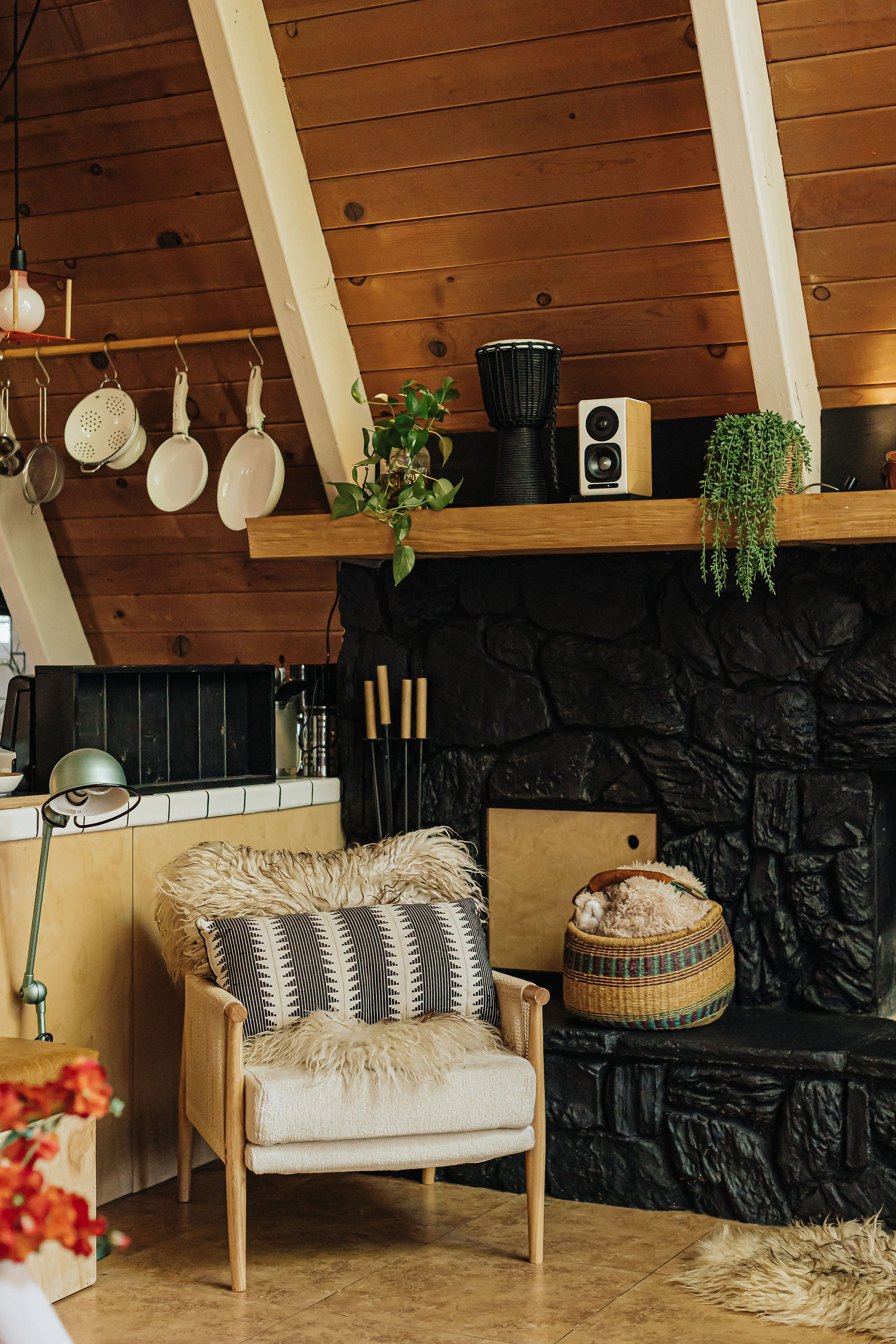 Cozy A-frame nook with stone fireplace and warm cabin charm