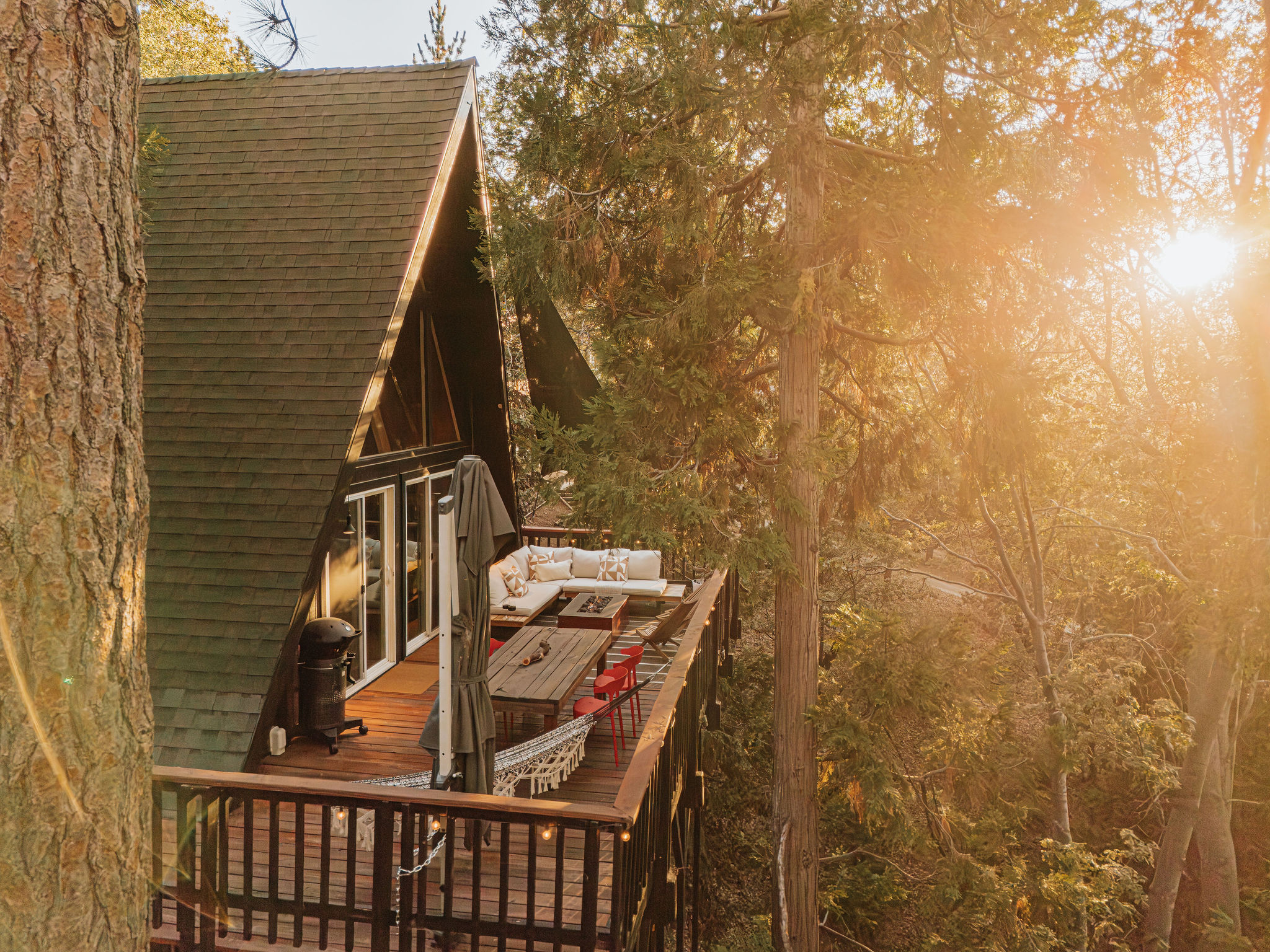Secluded A-frame cabin with sunny forest deck and outdoor lounge