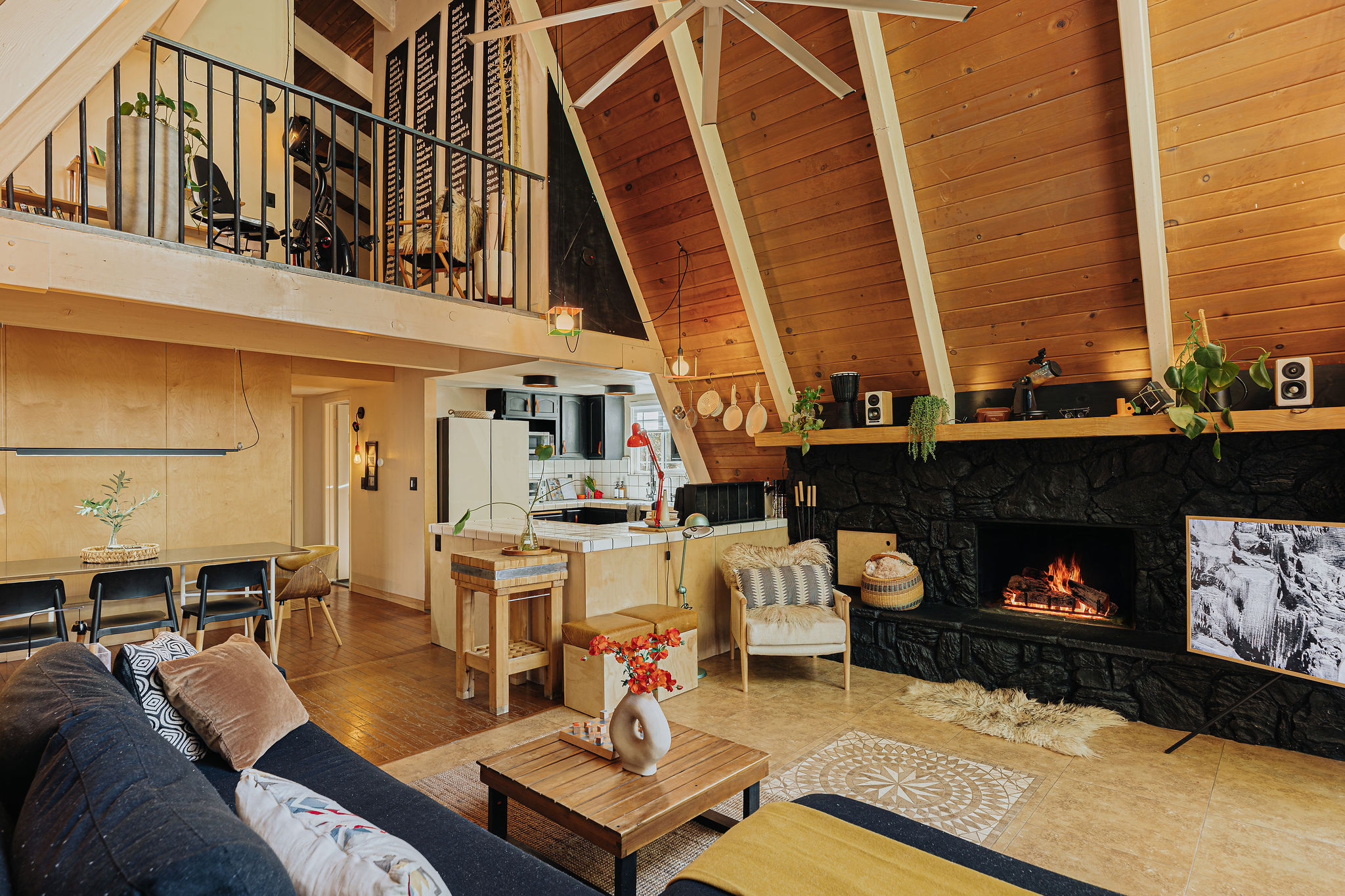 Cozy A-frame great room with loft, fireplace, and warm wood interiors