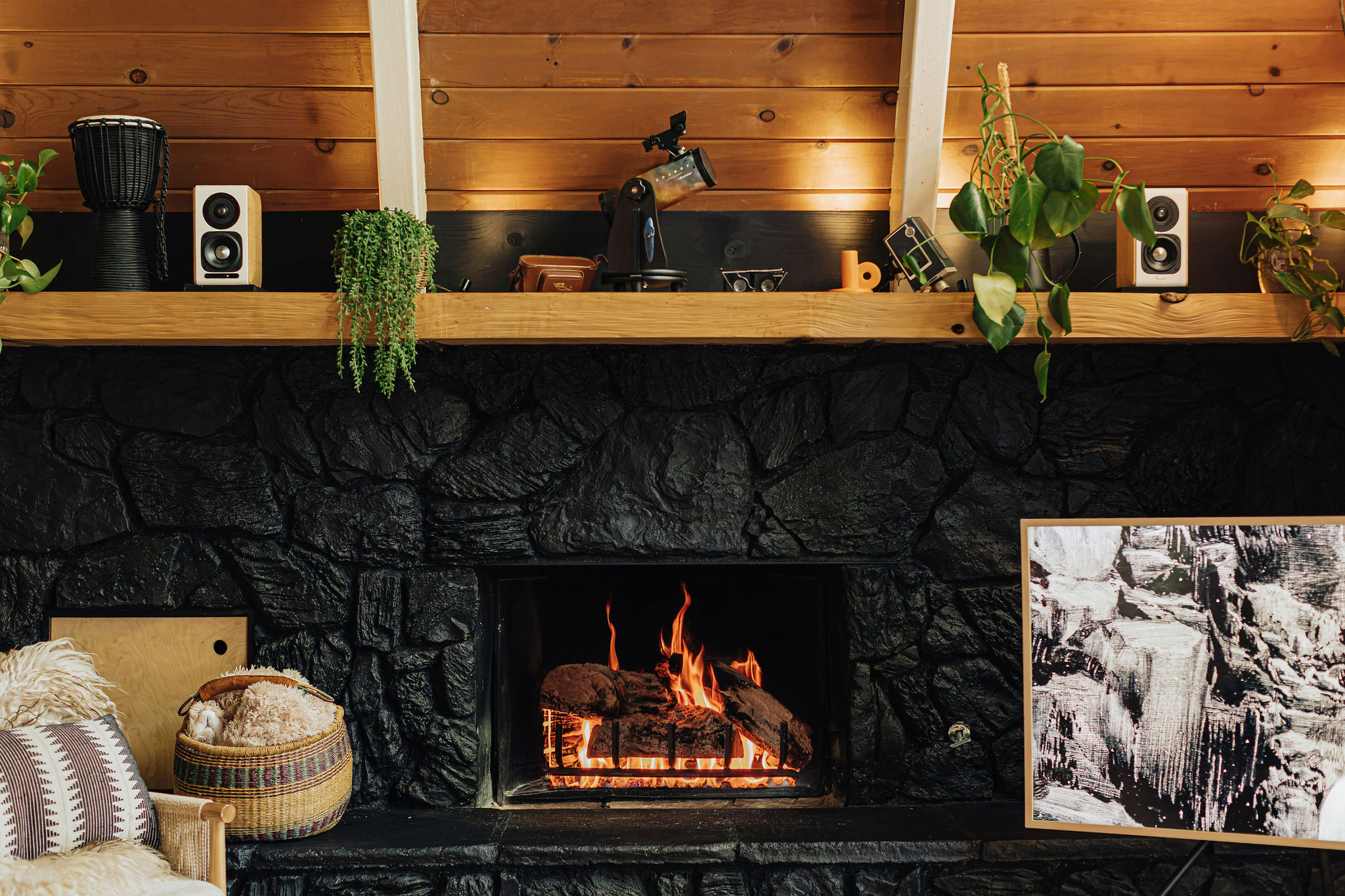Cozy stone fireplace with rustic wood accents and inviting cabin charm