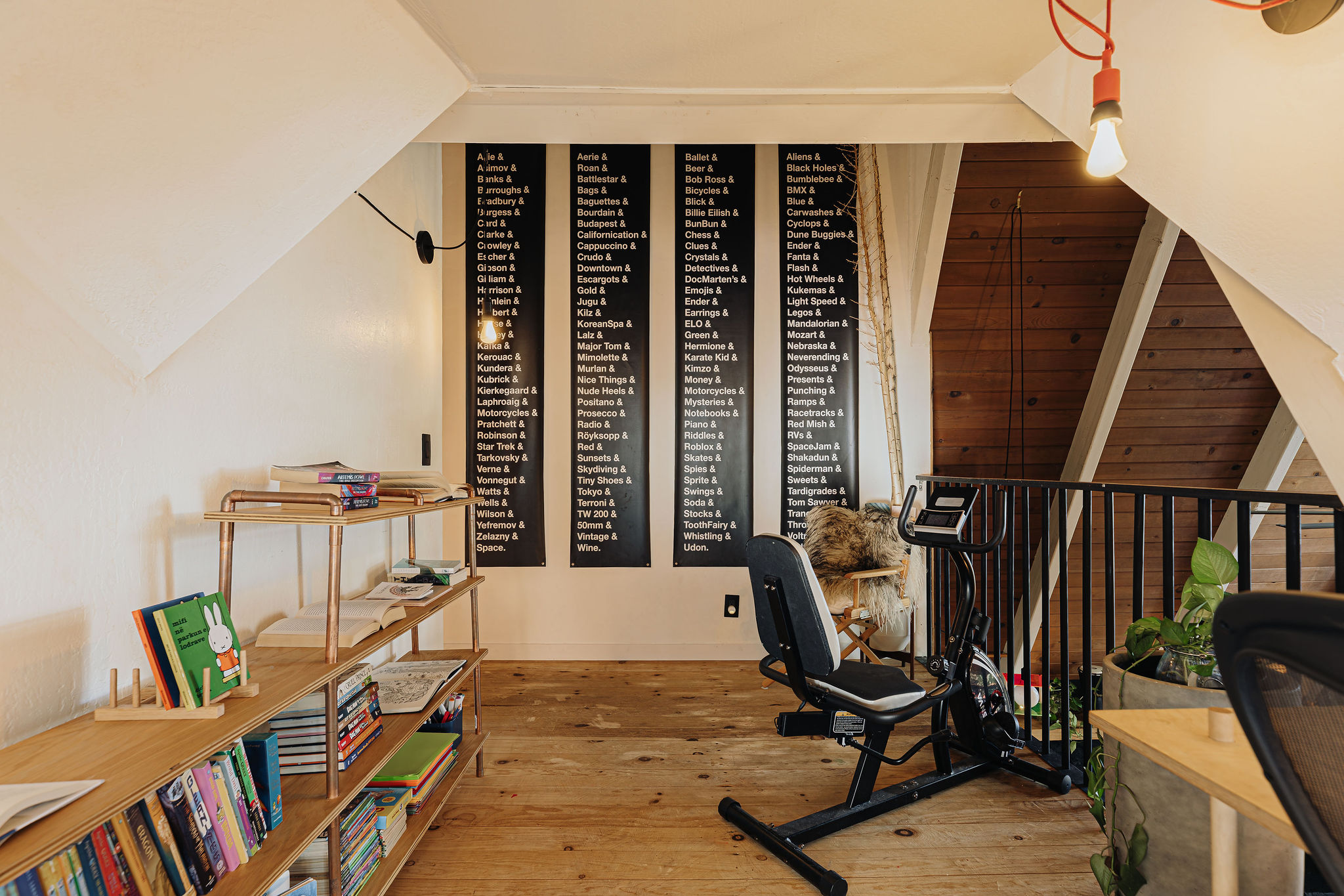 Cozy loft reading nook with books, games, and a fitness bike