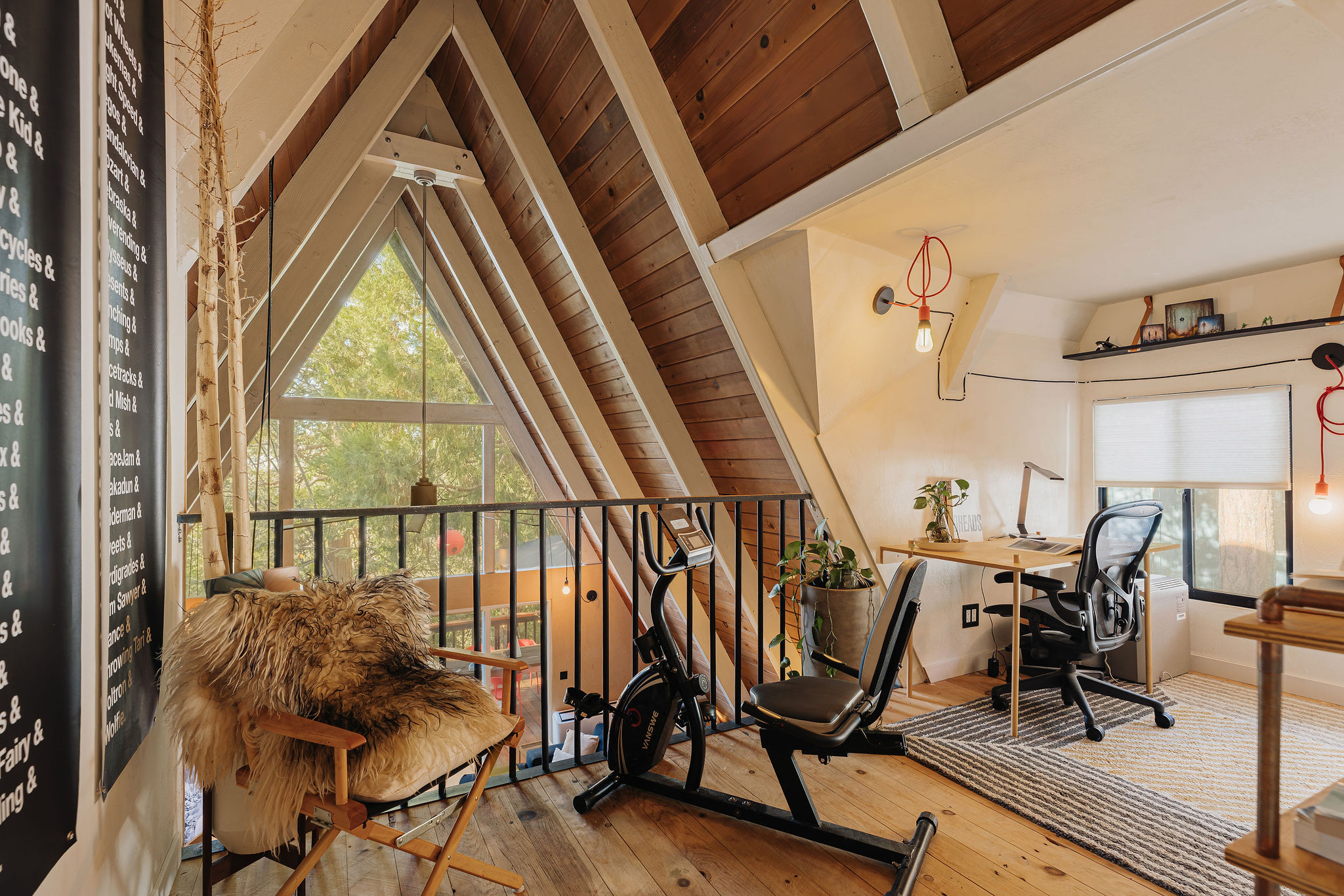 Bright A-frame loft with forest views, workspace, and fitness area